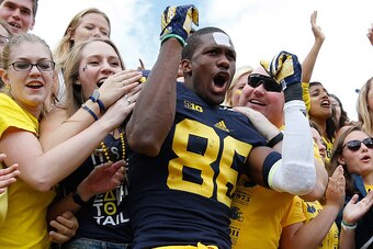 ANN ARBOR, MI - SEPTEMBER 19:  Jehu Chesson #86 of the Michigan Wolverines celebrates a 28-7 victory over the UNLV Rebels with fans on September 19, 2015 at Michigan Stadium in Ann Arbor, Michigan.  (Photo by Gregory Shamus/Getty Images)