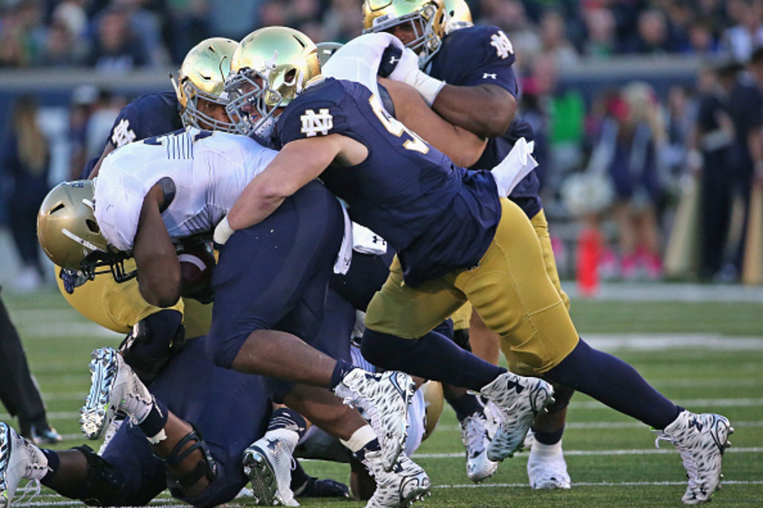 SOUTH BEND, IN - OCTOBER 10: Andrew Trumbetti #98 of the Notre Dame Fighting Irish tackles Chris Swain #37 of the Navy Midshipmen at Notre Dame Stadium on October 10, 2015 in South Bend, Indiana. Notre Dame defeated Navy 41-24. (Photo by Jonathan Daniel/G