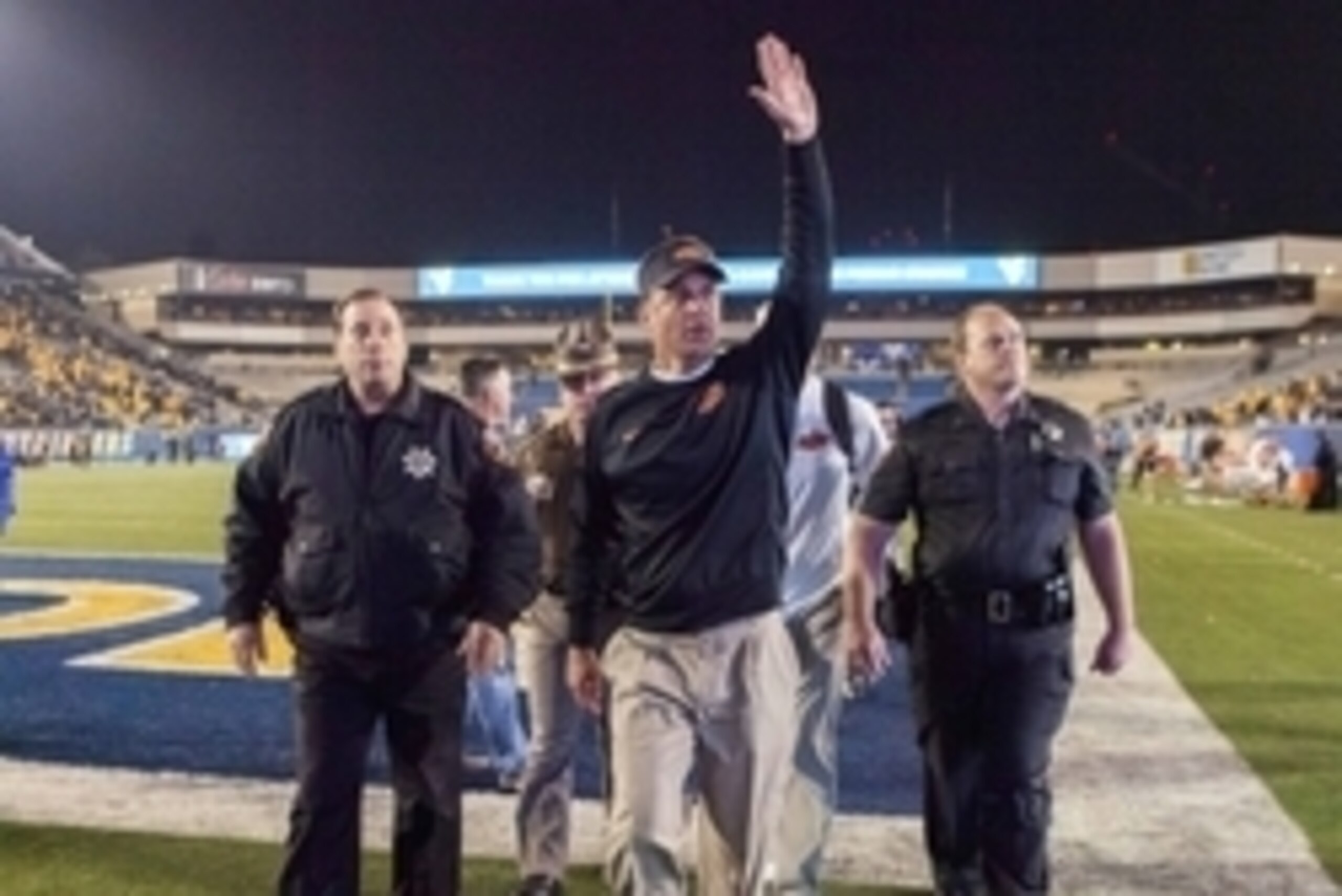 Oct 10, 2015; Morgantown, WV, USA; Oklahoma State Cowboys head coach Mike Gundy celebrates and waves to the crowd after beating the West Virginia Mountaineers at Milan Puskar Stadium. Oklahoma State won the game 33-26. Mandatory Credit: Ben Queen-USA TODA
