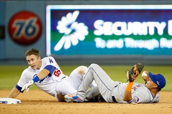 LOS ANGELES, CA - OCTOBER 10:  Ruben Tejada #11 of the New York Mets is hit by a slide by Chase Utley #26 of the Los Angeles Dodgers in the seventh inning in an attempt to turn a double play in game two of the National League Division Series at Dodger Sta