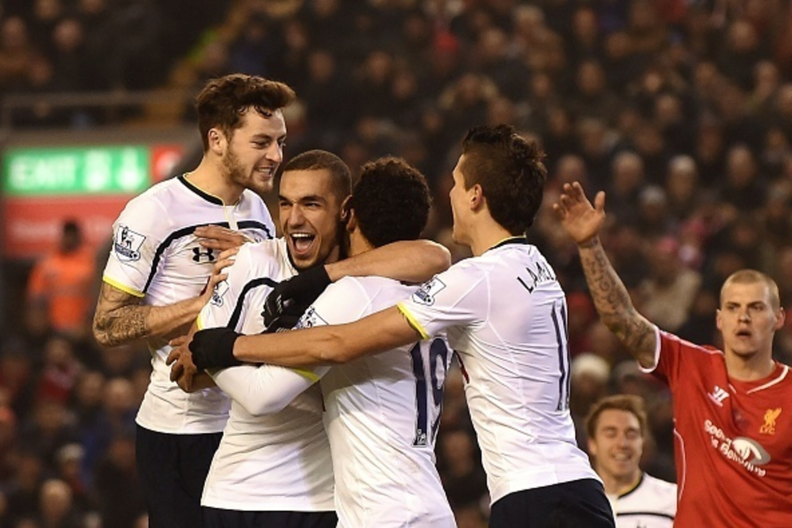 Tottenham Hotspur's Belgian midfielder Mousa Dembele (3L) is surrounded by team-mates Tottenham Hotspur's French defender Younes Kaboul (2L) and Tottenham Hotspur's Argentinian midfielder Erik Lamela (2R) celebrating after Dembele scored their second goal