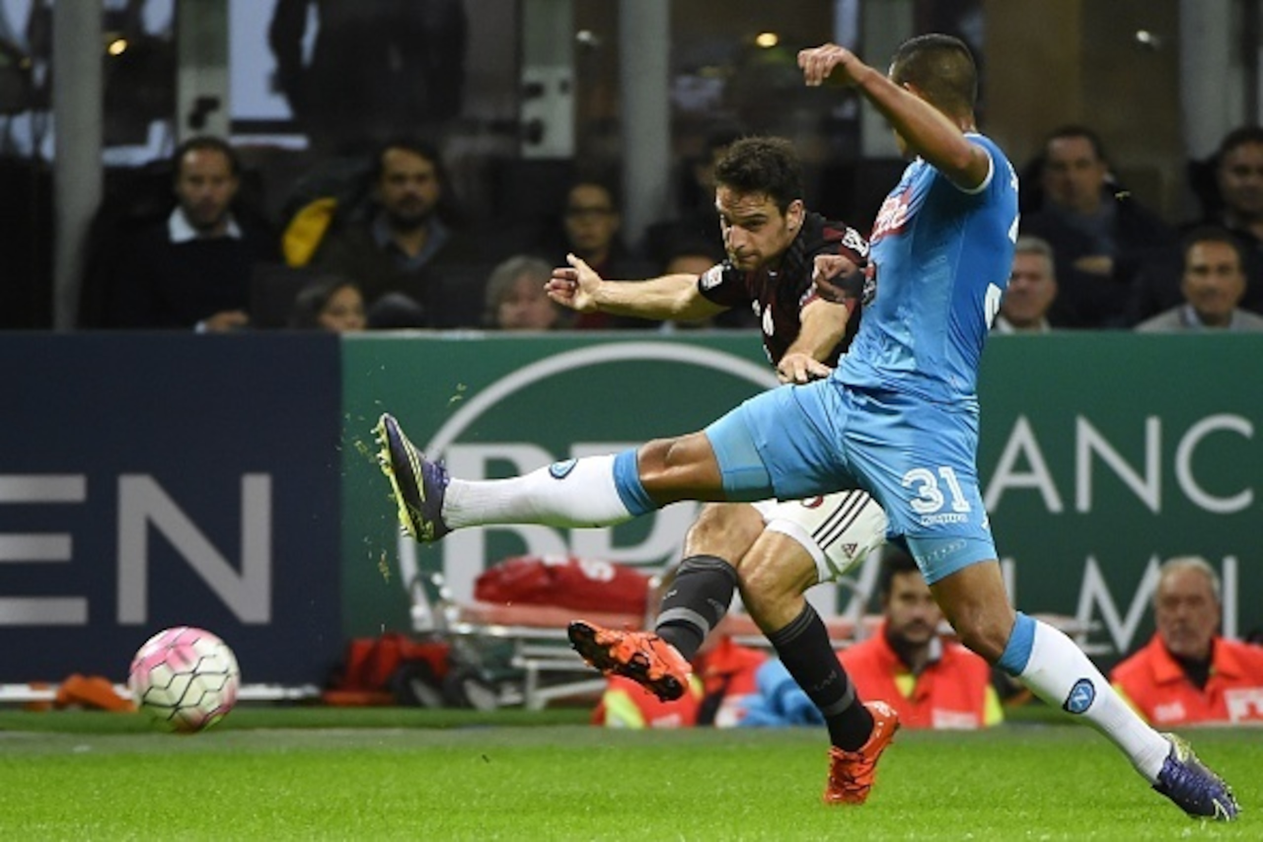 AC Milan's midfielder Giacomo Bonaventura (L) vies for the ball with Napoli's Algerian defender Faouzi Ghoulam during the Italian Serie A football match between AC Milan and Napoli at San Siro Stadium in Milan on October 4,  2015. AFP PHOTO / OLIVIER MORI