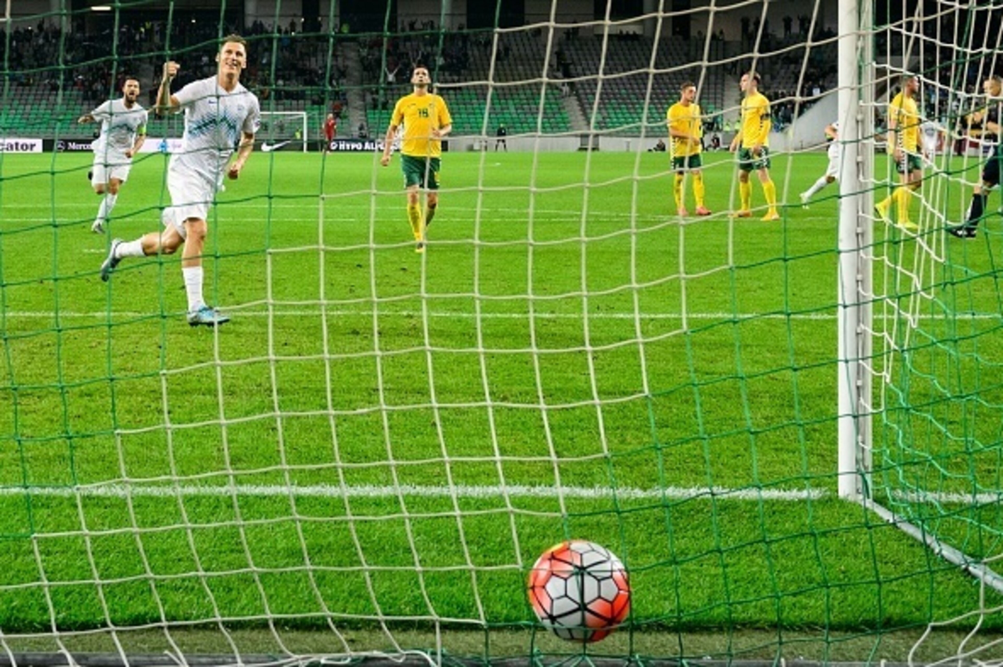 Slovenia's Valter Birsa (L) celebrates scoring the opening goal past Lithuania's goalkeeper Emilijus Zubas during the Euro 2016 Group E qualifying football match between Slovenia and Lithuania at the Stozice stadium in Ljubljana, Slovenia on October 9, 2 Slovenia's Valter Birsa (L) celebrates scoring the opening goal past Lithuania's goalkeeper Emilijus Zubas during the Euro 2016 Group E qualifying football match between Slovenia and Lithuania at the Stozice stadium in Ljubljana, Slovenia on October 9, 2