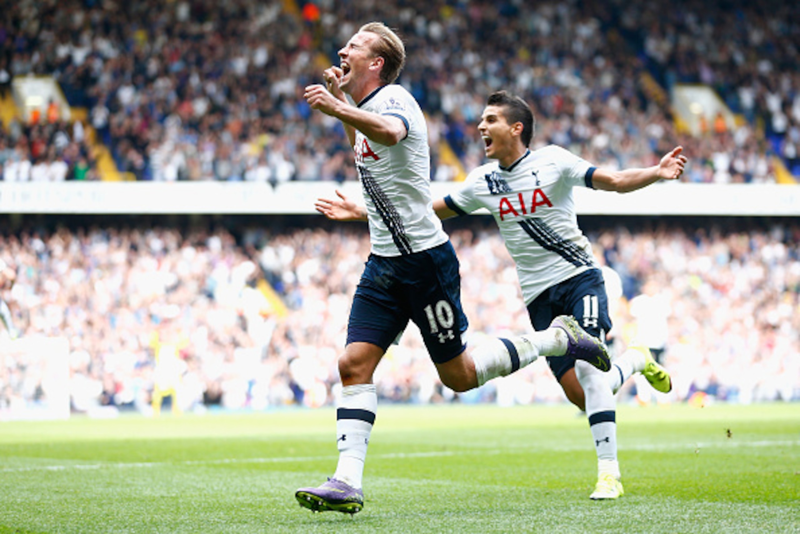 LONDON, ENGLAND - SEPTEMBER 26:  Harry Kane of Tottenham Hotspur celebrates scoring a goal as team mate Erik Lamela of Tottenham Hotspur follows during the Barclays Premier League match between Tottenham Hotspur and Manchester City at White Hart Lane on S