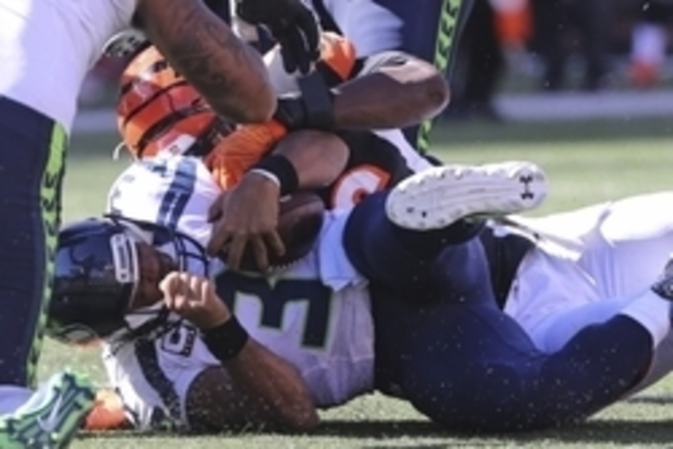 Oct 11, 2015; Cincinnati, OH, USA; Seattle Seahawks quarterback Russell Wilson (3) is sacked by Cincinnati Bengals defensive end Carlos Dunlap (96) in the second half at Paul Brown Stadium. The Bengals won 27-24. Mandatory Credit: Aaron Doster-USA TODAY S