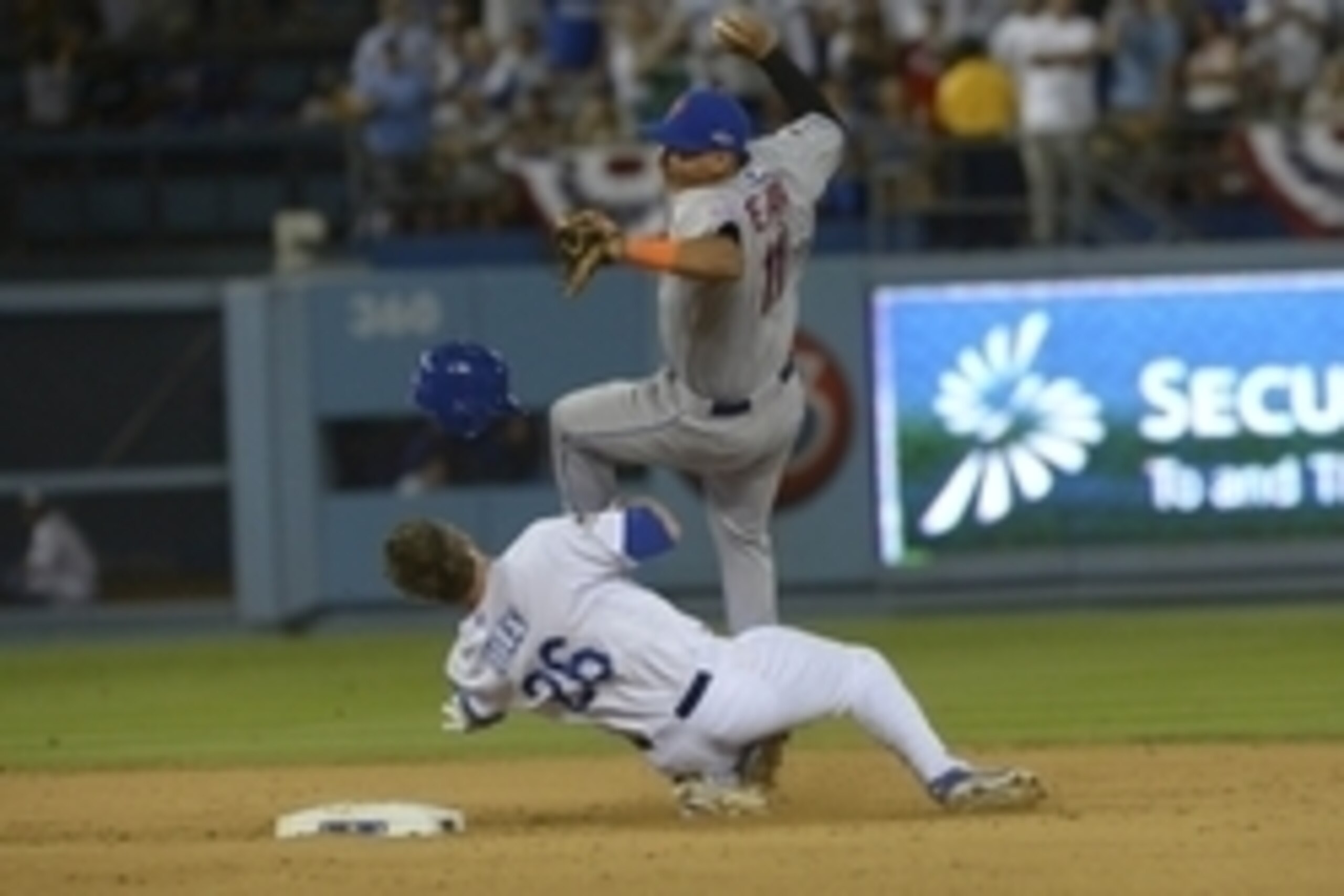 Oct 10, 2015; Los Angeles, CA, USA; New York Mets shortstop Ruben Tejada (11) collides with Los Angeles Dodgers second baseman Chase Utley (26) at second base during the seventh inning in game two of the NLDS at Dodger Stadium. Mandatory Credit: Jayne Kam