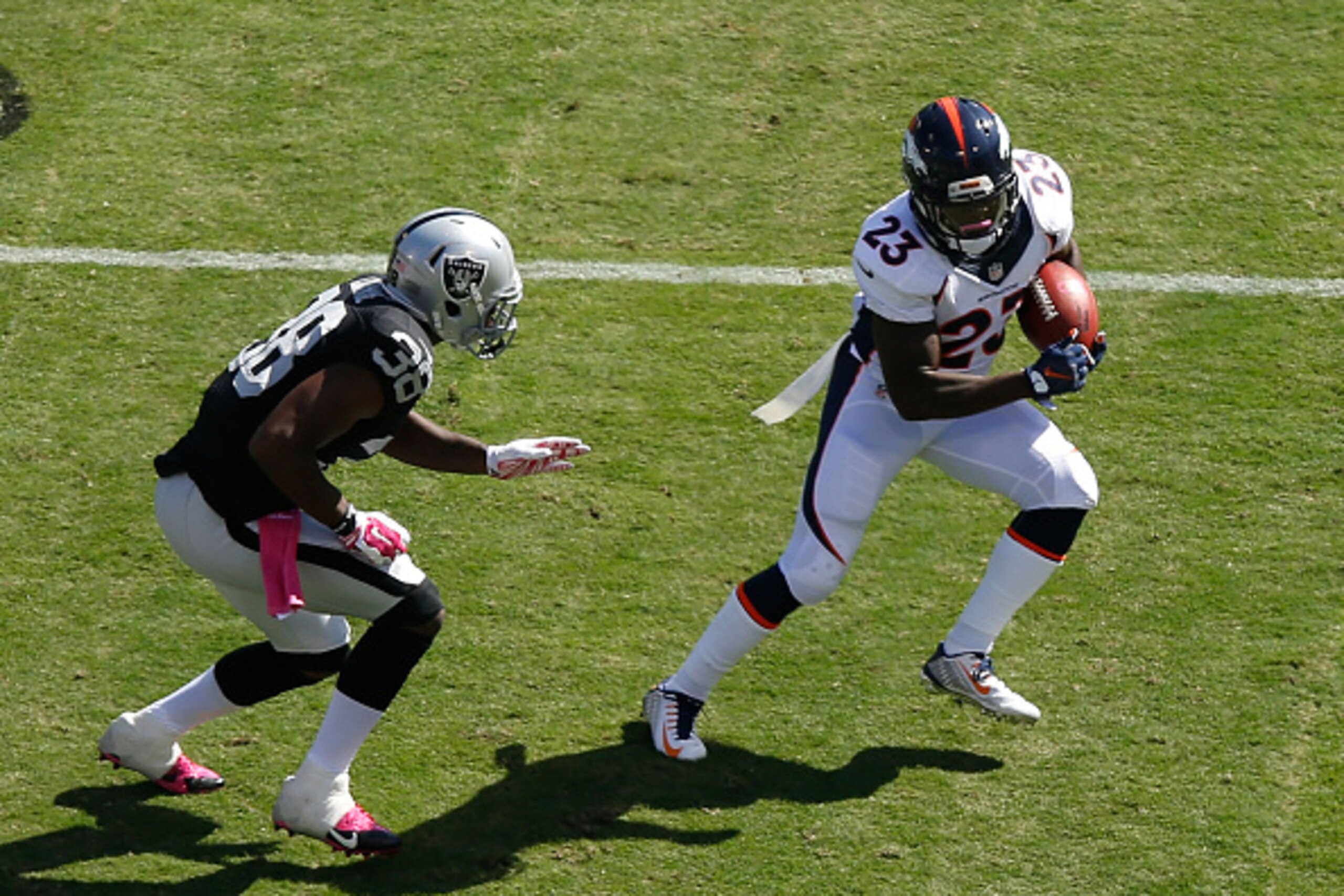 OAKLAND, CA - OCTOBER 11: Ronnie Hillman #23 of the Denver Broncos avoids the tackle of T.J. Carrie #38 of the Oakland Raiders in the first quarter at O.co Coliseum on October 11, 2015 in Oakland, California. (Photo by Ezra Shaw/Getty Images) OAKLAND, CA - OCTOBER 11: Ronnie Hillman #23 of the Denver Broncos avoids the tackle of T.J. Carrie #38 of the Oakland Raiders in the first quarter at O.co Coliseum on October 11, 2015 in Oakland, California. (Photo by Ezra Shaw/Getty Images)