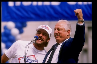 LOS ANGELES, CA - OCTOBER 25:  Outfielder Kirk Gibson #23 and manager Tommy Lasorda #2 of the Los Angeles Dodgers speak to the croad at the Victory Parade for the Los Angeles Dodgers on October 25, 1988 in Los Angeles, California.  (Photo by Mike Powell/G