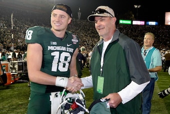 PASADENA, CA - JANUARY 01:  Quarterback Connor Cook #18 of the Michigan State Spartans poses with the manager of the Arizona Diamondbacks, Kirk Gibson, after their 24-20 win over the Stanford Cardinal in the 100th Rose Bowl Game presented by Vizio at the 