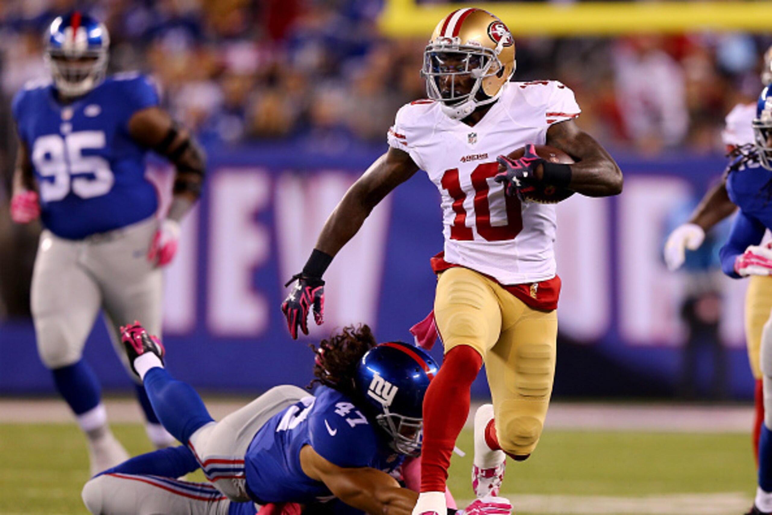 EAST RUTHERFORD, NJ - OCTOBER 11:  Bruce Ellington #10 of the San Francisco 49ers carries the ball as  Trumaine McBride #38 and  Uani' Unga #47 of the New York Giants defend in the first quarter during at MetLife Stadium on October 11, 2015 in East Ruther