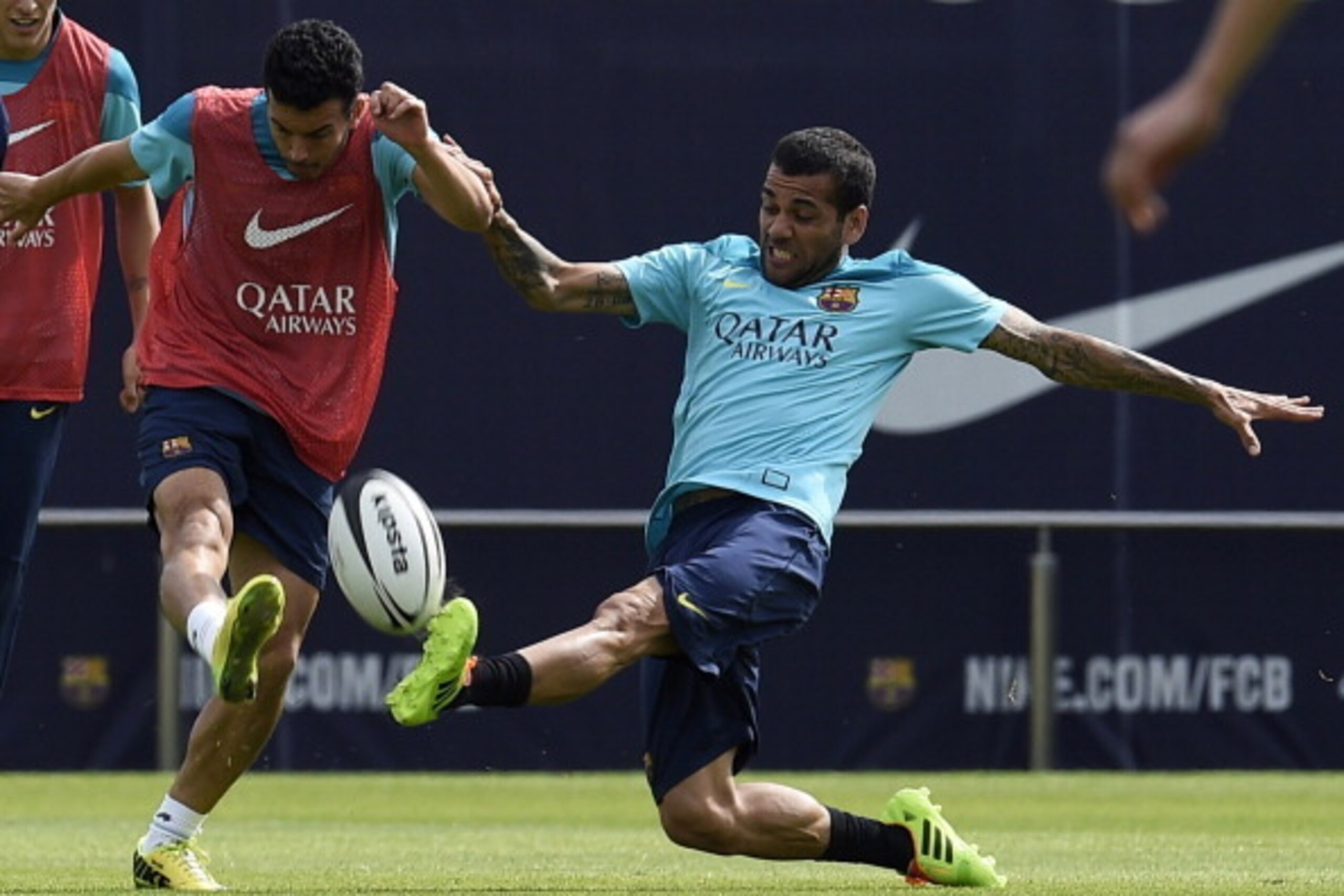 Barcelona's Brazilian defender Dani Alves (R) and Barcelona's forward Pedro Rodriguez (L) play with a rugby ball during a training session at the Sports Center FC Barcelona Joan Gamper in Sant Joan Despi, near Barcelona on April 15, 2014 on the eve of the Barcelona's Brazilian defender Dani Alves (R) and Barcelona's forward Pedro Rodriguez (L) play with a rugby ball during a training session at the Sports Center FC Barcelona Joan Gamper in Sant Joan Despi, near Barcelona on April 15, 2014 on the eve of the