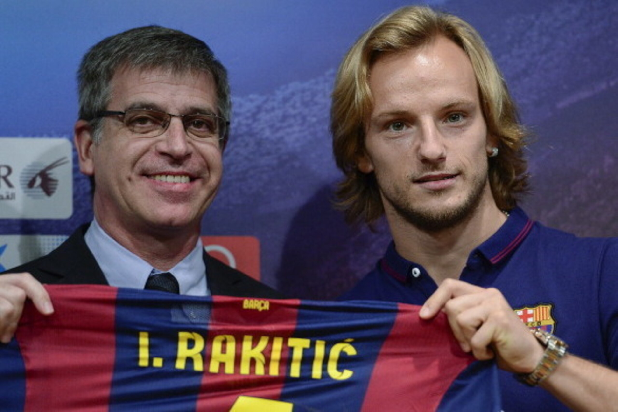 FC Barcelona's new Croatian midfielder Ivan Rakitic (R) poses with Barcelona's vice-president Jordi Mestre during his presentation at the Camp Nou stadium in Barcelona on July 1, 2014. Croatian midfielder Ivan Rakitic from Sevilla signed a five-year contr FC Barcelona's new Croatian midfielder Ivan Rakitic (R) poses with Barcelona's vice-president Jordi Mestre during his presentation at the Camp Nou stadium in Barcelona on July 1, 2014. Croatian midfielder Ivan Rakitic from Sevilla signed a five-year contr