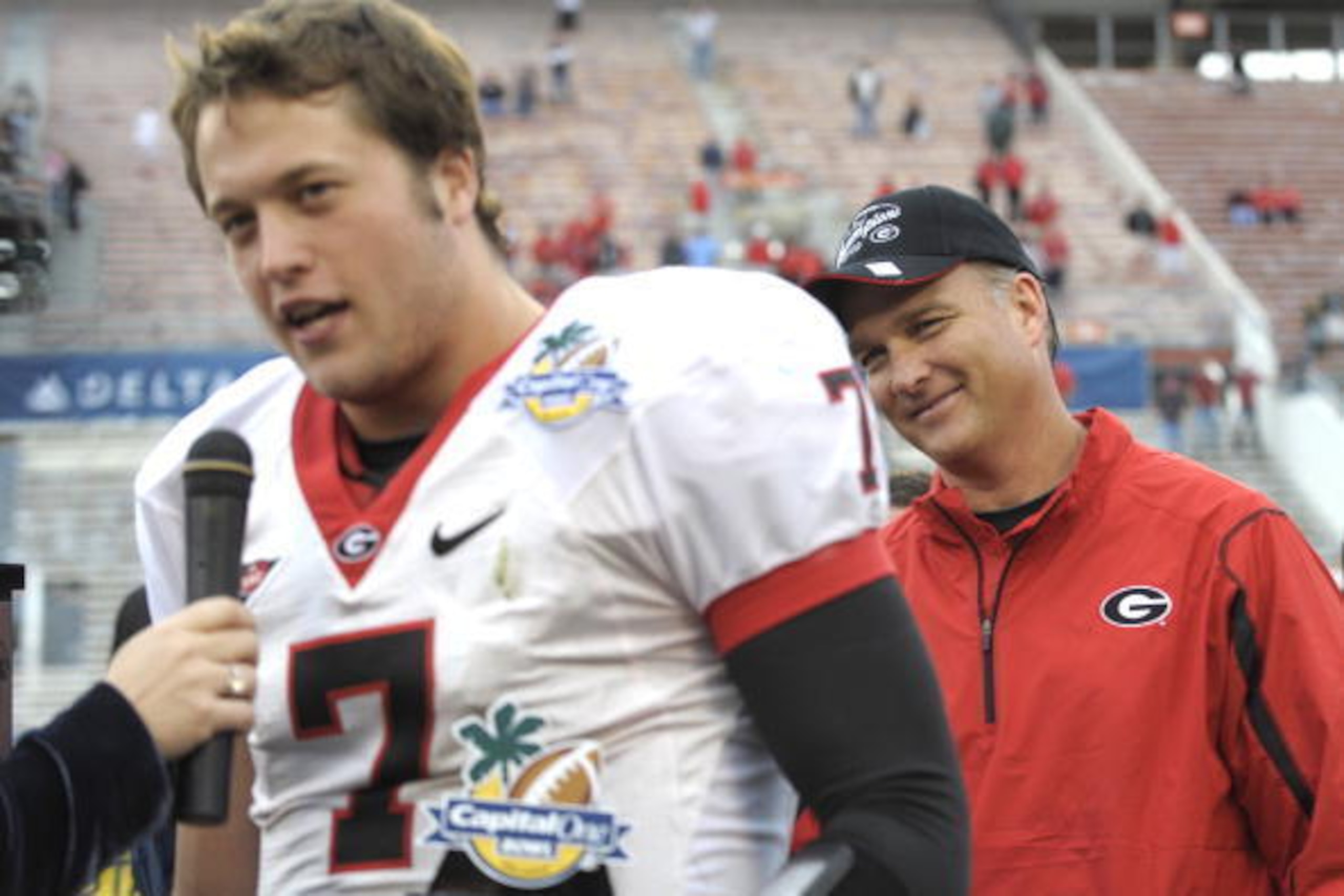 ORLANDO, FL - JANUARY 1: Quarterback Matthew Stafford #7 of the University of Georgia talks to the media while coach Mark Richt watches after play against the Michigan State Spartans at the 2009 Capital One Bowl at the Citrus Bowl on January 1, 2009 in Or