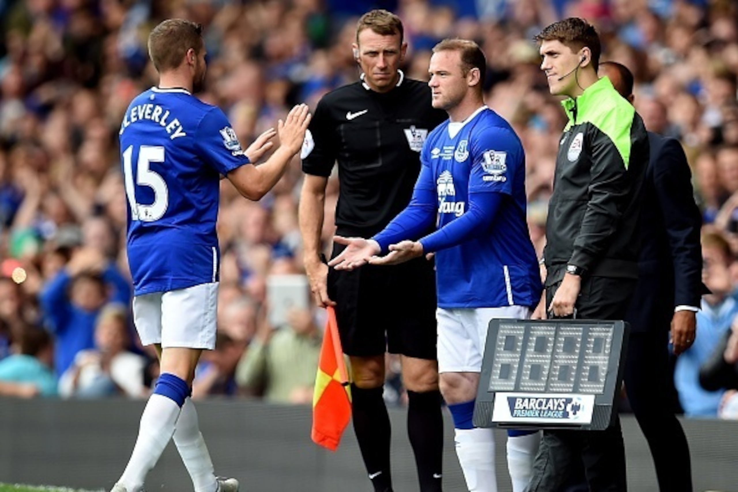 Manchester United's former Everton forward Wayne Rooney comes on as a substitute for Everton's English midfielder Tom Cleverley (L) during the Duncan Ferguson Testimonal pre-season friendly football match between Everton and Villarreal at Goodison Park in