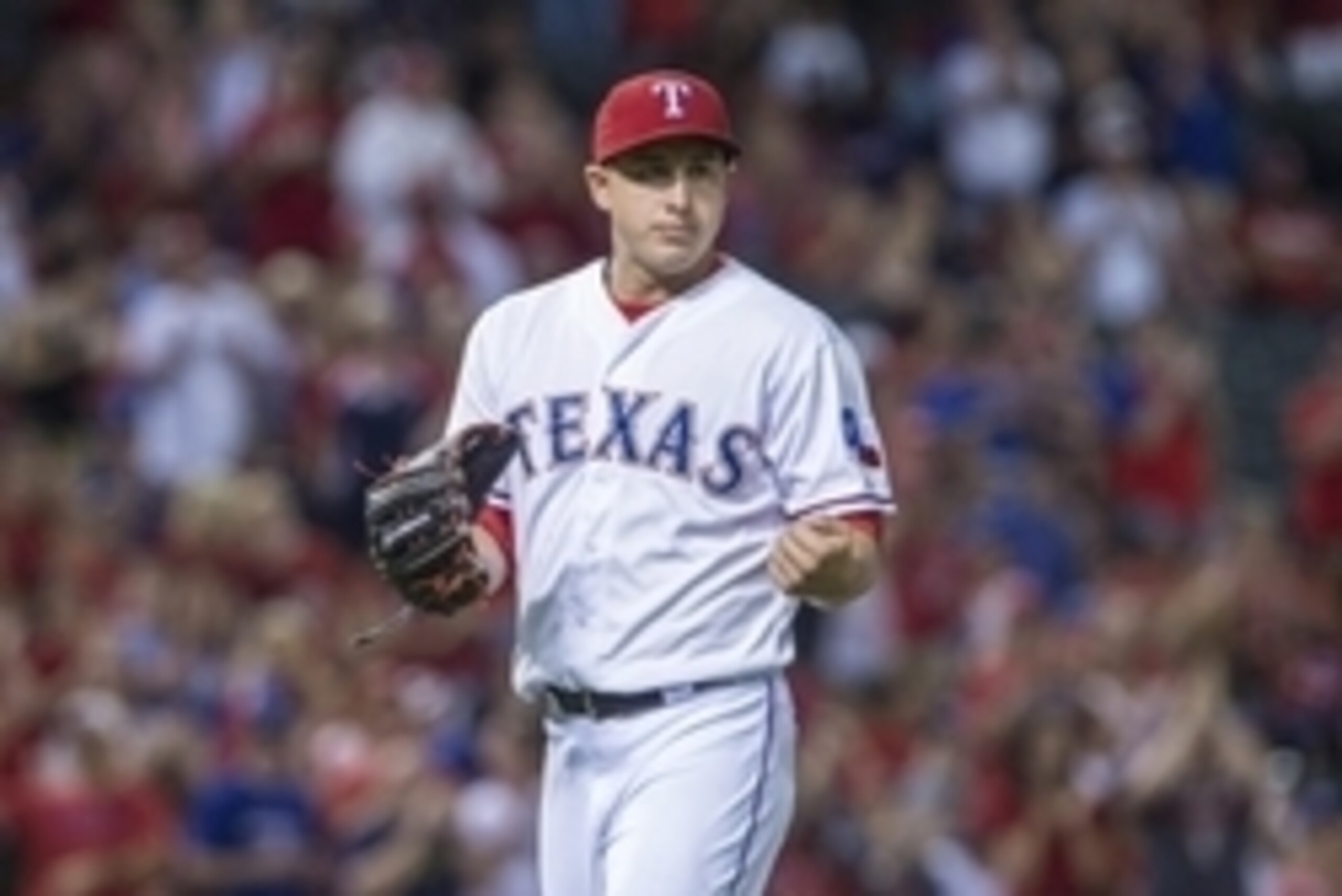 Oct 1, 2015; Arlington, TX, USA; Texas Rangers starting pitcher Derek Holland (45) leaves the game during the seventh inning against the Los Angeles Angels at Globe Life Park in Arlington. The Rangers defeat the Angels 5-3. Mandatory Credit: Jerome Miron-