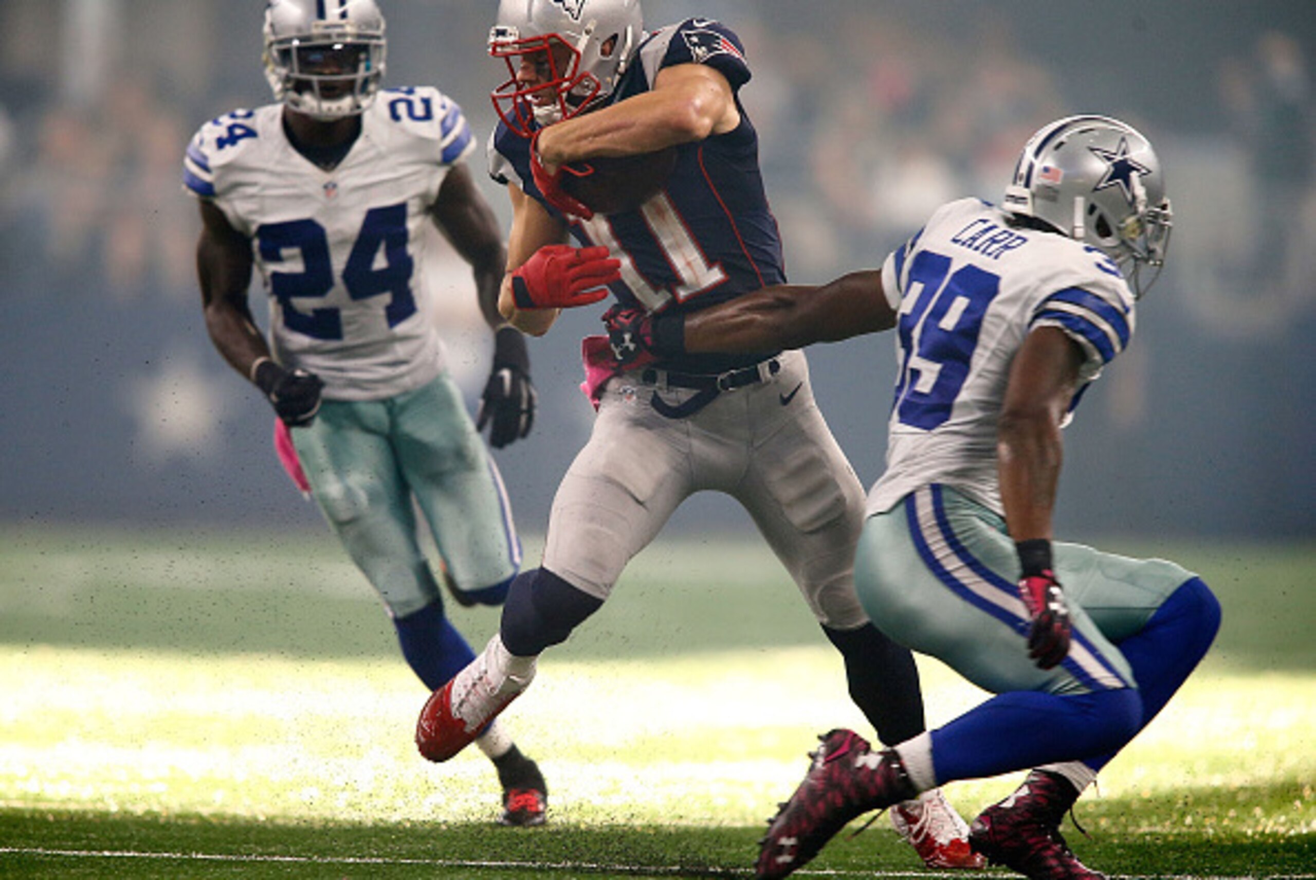 ARLINGTON, TX - OCTOBER 11:  Julian Edelman #11 of the New England Patriots cuts between Morris Claiborne #24 of the Dallas Cowboys and Brandon Carr #39 of the Dallas Cowboys on his way to a touchdown during the second half of the NFL game at AT&T Stadium