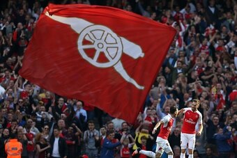 Arsenal's German midfielder Mesut Ozil (L) celebrates with team mate Arsenal's Welsh midfielder Aaron Ramsey after scoring during the English Premier League football match between Arsenal and Manchester United at the Emirates Stadium in London on October 