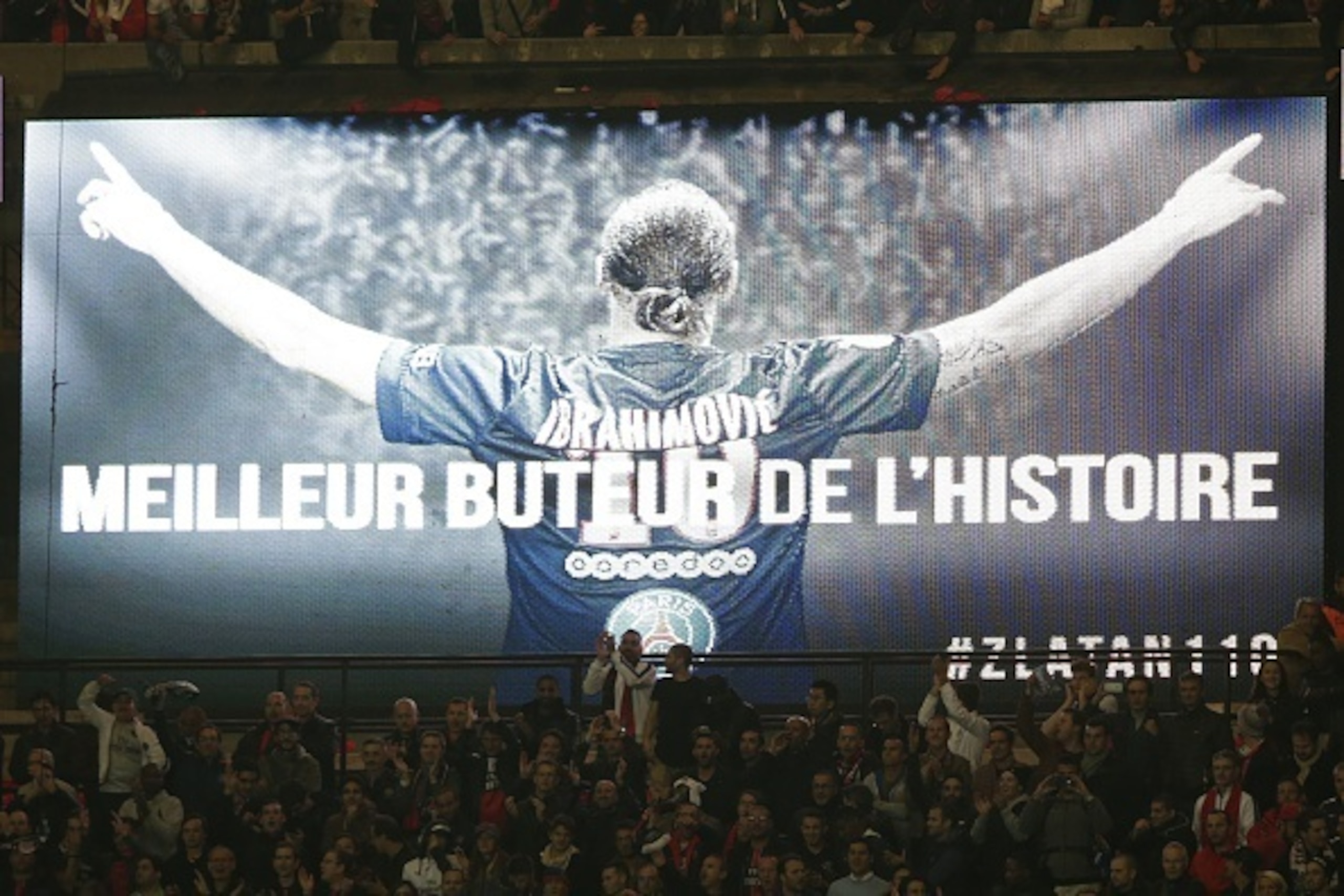 A screen with a message reading 'Best striker in the history' showing a picture Paris Saint-Germain's Swedish forward Zlatan Ibrahimovic is seen during the French L1 football match Paris Saint-Germain (PSG) vs Olympique de Marseille (OM) on October 4, 201