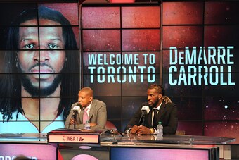 TORONTO, CANADA - JULY 9:  Masai Ujiri, GM of the Toronto Raptors, introduces DeMarre Carroll during a press conference on July 9, 2015 at the Air Canada Centre in Toronto, Ontario, Canada.  NOTE TO USER: User expressly acknowledges and agrees that, by do