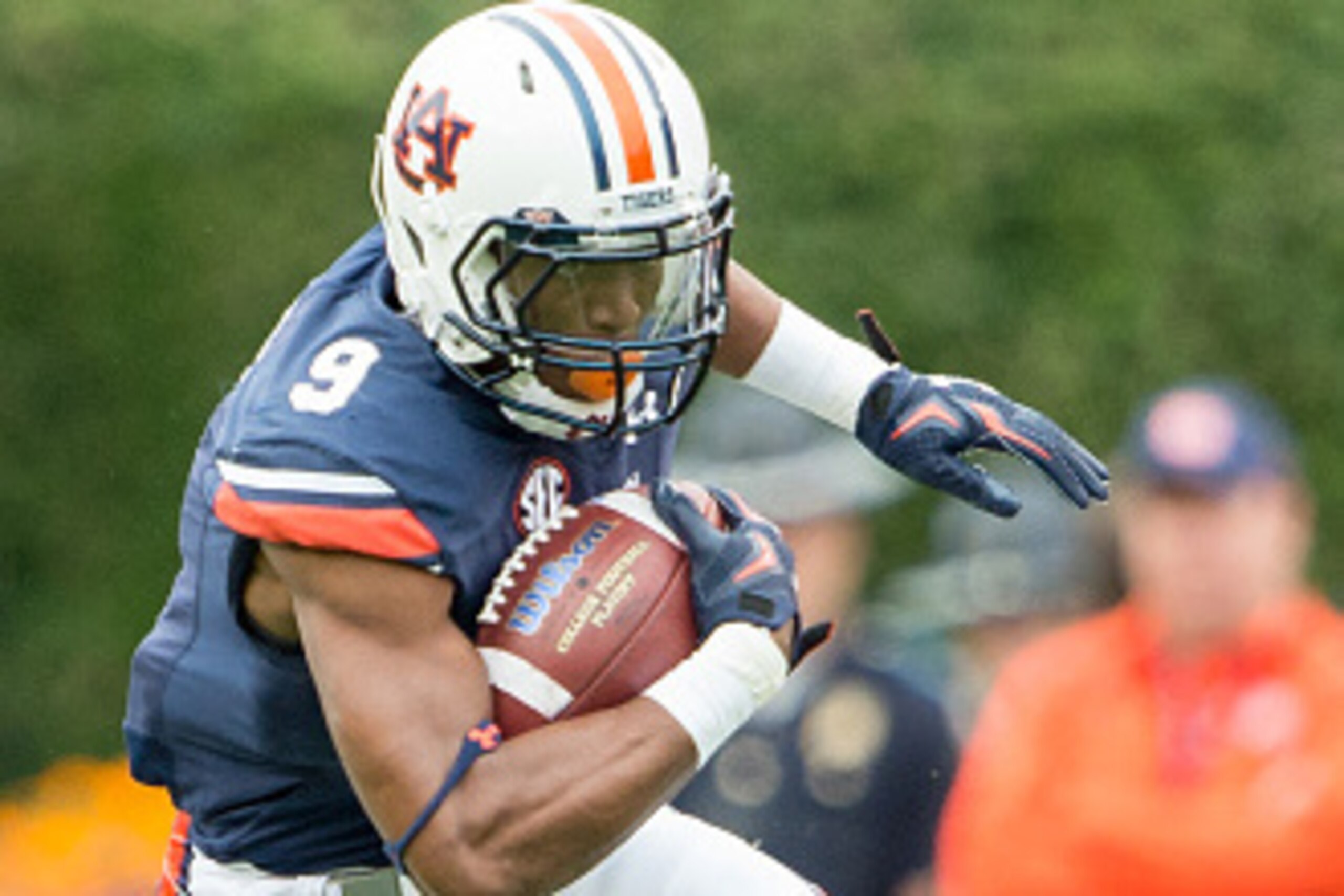 AUBURN, AL - OCTOBER 3: Running back Roc Thomas (9) of the Auburn Tigers dodges a tackle by \defensive tackle Tony Popovich (98) of the San Jose State Spartans on October 3, 2015 at Jordan-Hare Stadium in Auburn, Alabama. The Auburn Tigers defeated the Sa