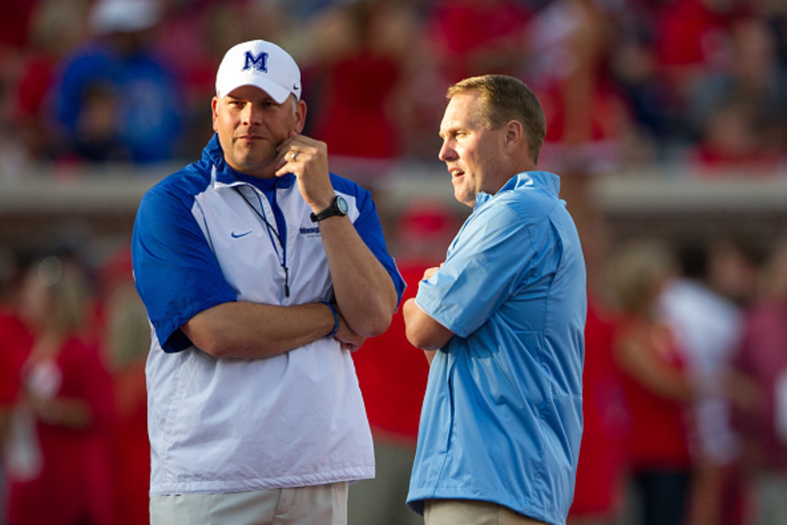 OXFORD, MS - SEPTEMBER 27: Head coach Hugh Freeze of the Mississippi Rebels talks with head coach Justin Fuente of the Memphis Tigers on September 27, 2014 at Vaught-Hemingway Stadium in Oxford, Mississippi. The Mississippi Rebels defeated the Memphis Tig