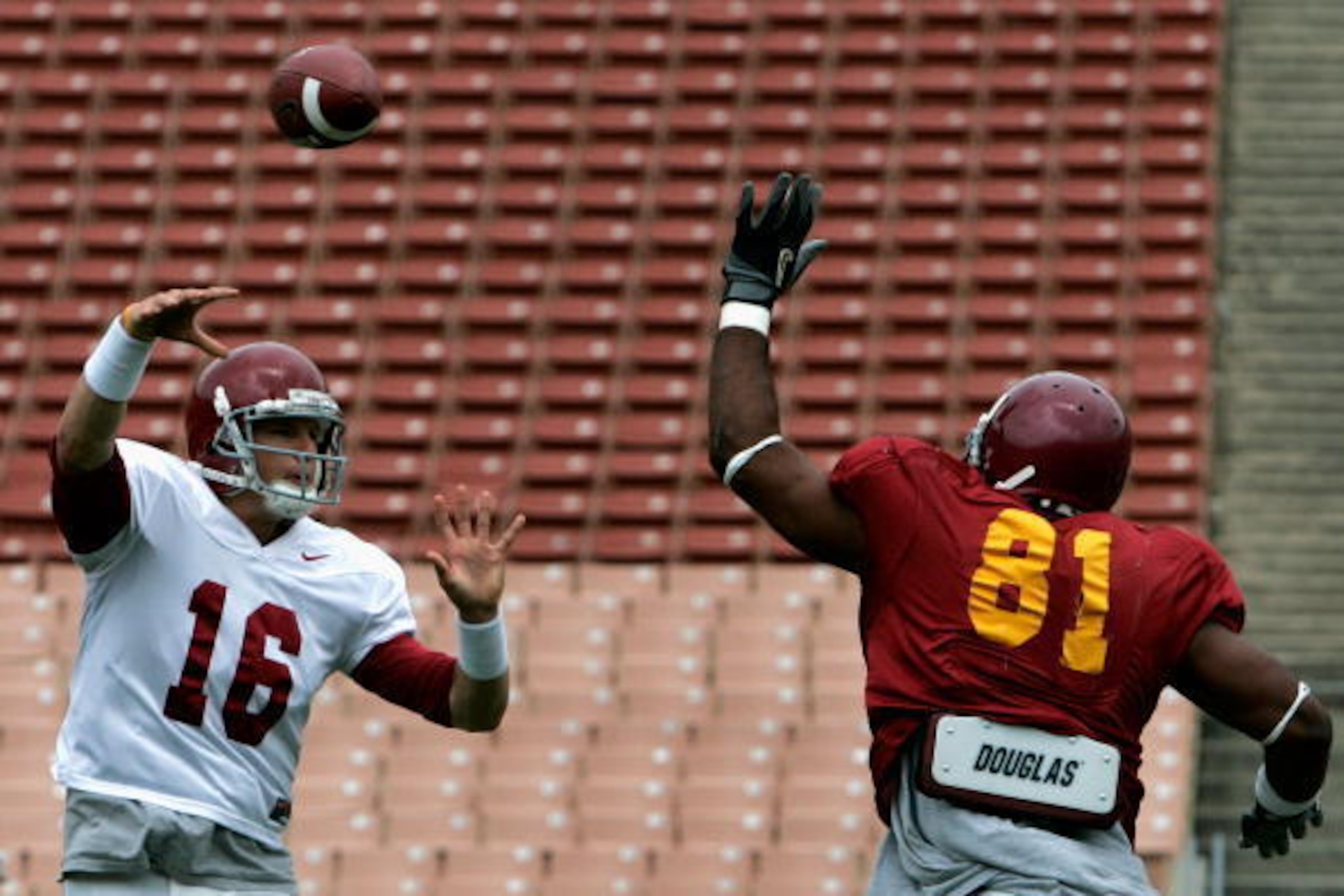 LOS ANGELES, CA - APRIL 19:  Quarterback Mitch Mustain #16 of the USC Trojans white team throws a pass reception over Gerald Washington #81 of the USC Trojans cardinal team during the spring practice game at Los Angeles Memorial Coliseum on April 19, 2008