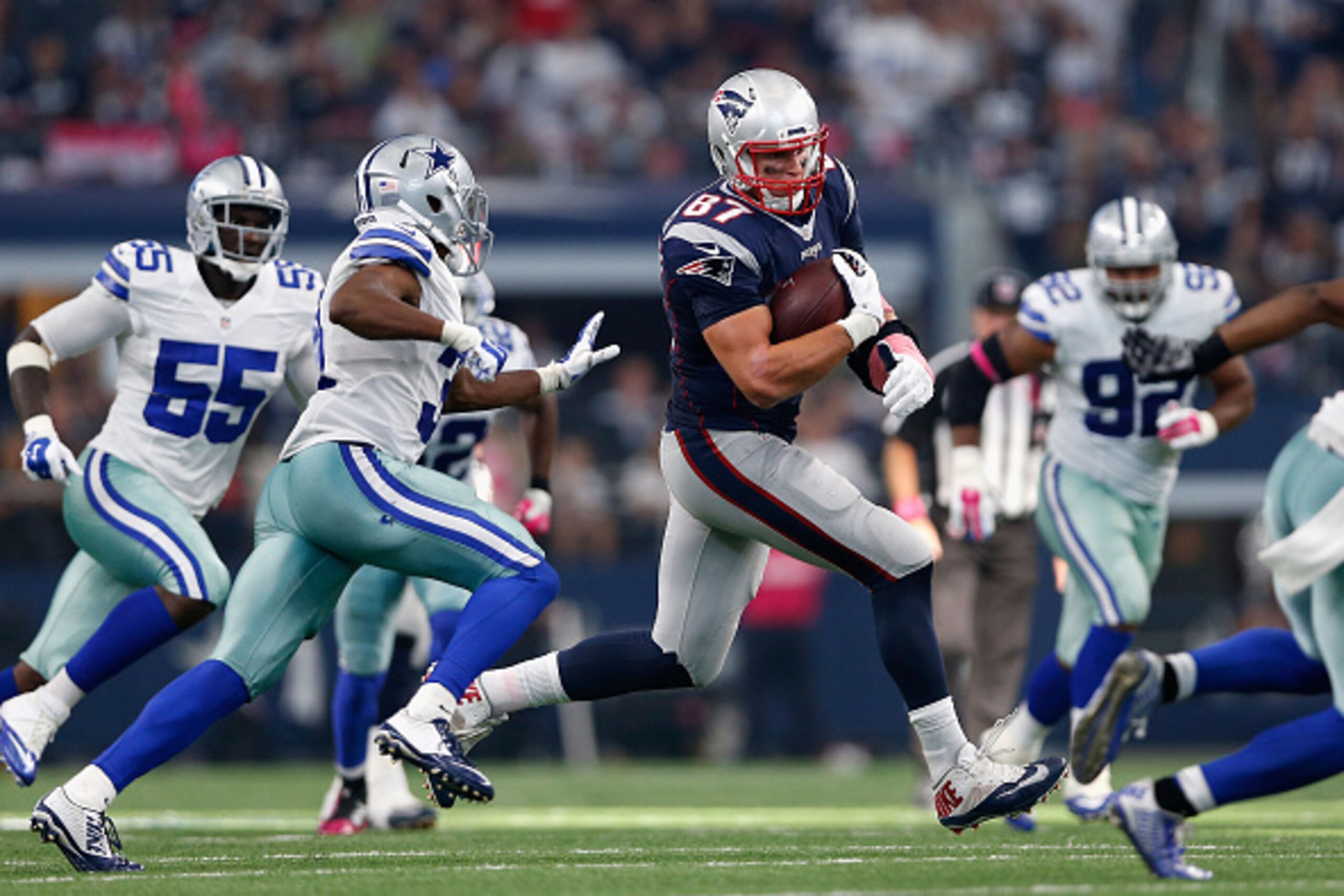 ARLINGTON, TX - OCTOBER 11:  Tight end Rob Gronkowski #87 of the New England Patriots runs with the football after a reception past cornerback Byron Jones #31 of the Dallas Cowboys during the second half of the NFL game at AT&T Stadium on October 11, 2015