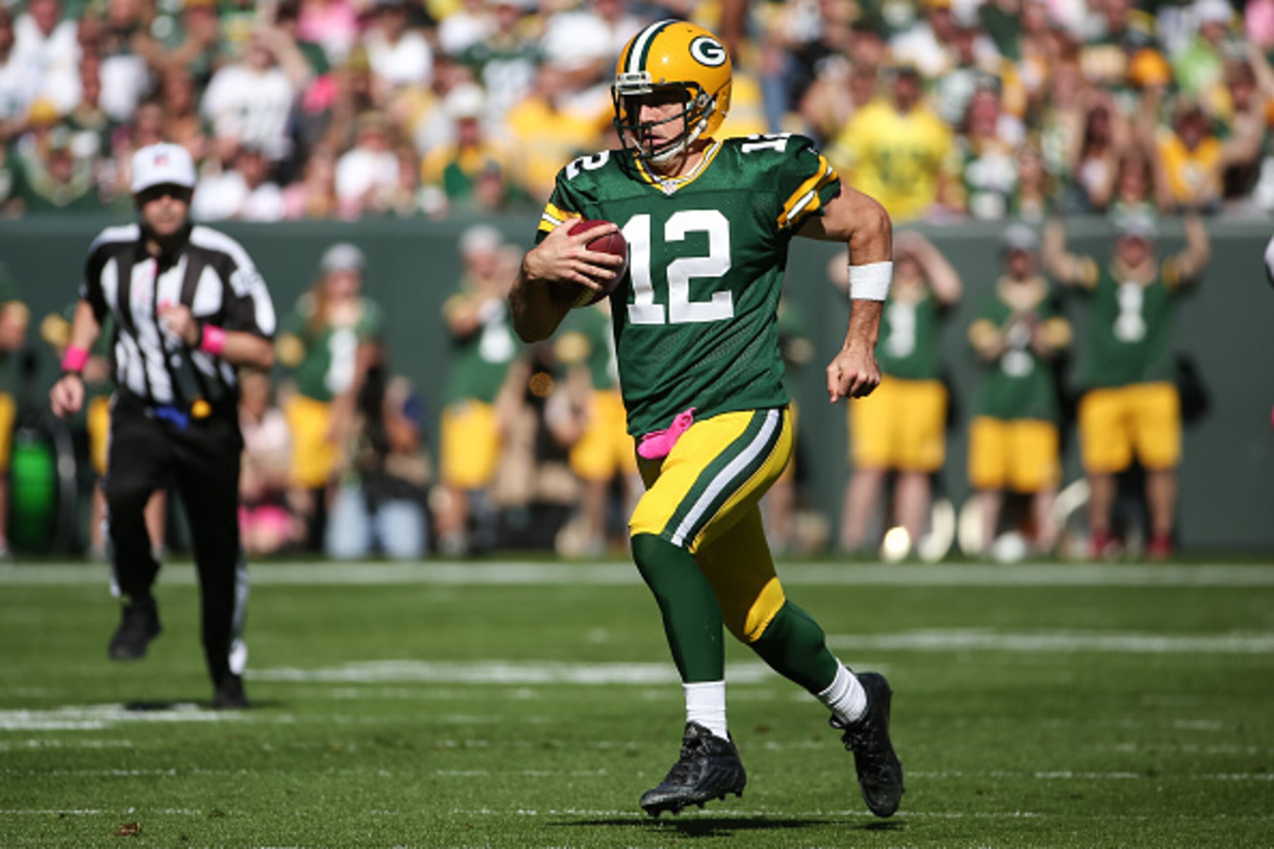 GREEN BAY, WI - OCTOBER 11:  Quarterback  Aaron Rodgers #12 of the Green Bay Packers carries the football up the field against the St. Louis Rams in the first quarter at Lambeau Field on October 11, 2015 in Green Bay, Wisconsin.  (Photo by Jonathan Daniel