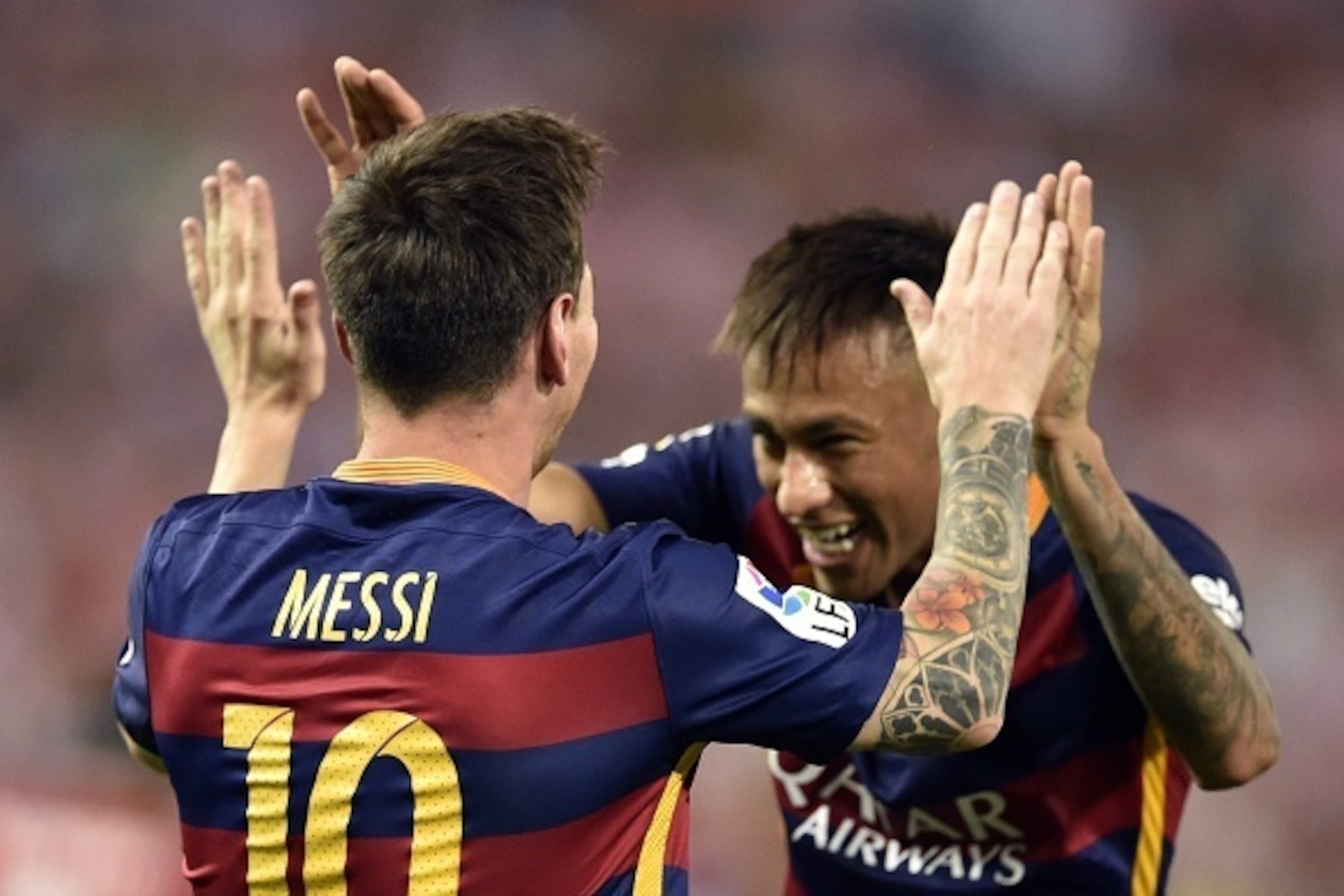 Barcelona's Argentinian forward Lionel Messi (L) celebrates a goal with Barcelona's Brazilian forward Neymar (R) during the Spanish league football match Club Atletico de Madrid vs FC Barcelona at the Vicente Calderon stadium in Madrid on September 12, 20