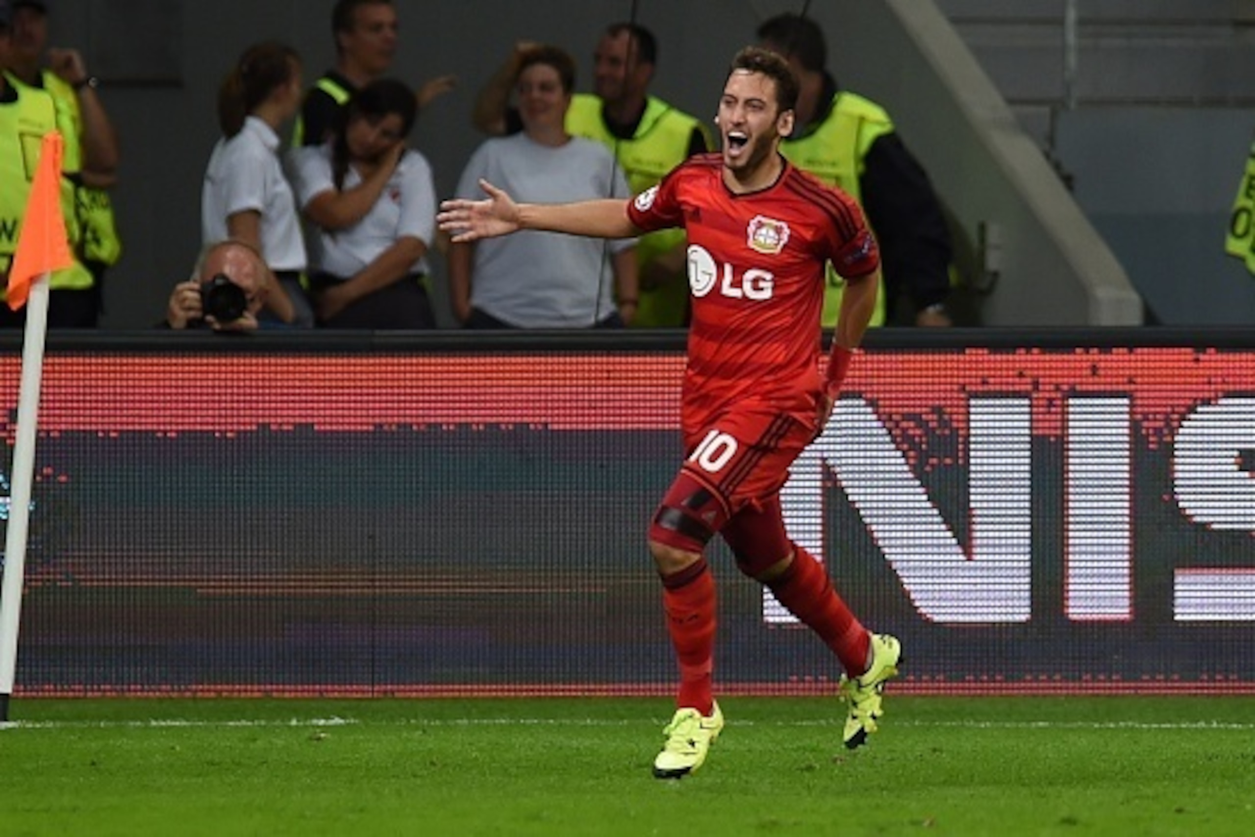 Leverkusen's midfielder Hakan Calhanoglu celebrates scoring during the UEFA Champions League playoff football match between Bayer Leverkusen and SS Lazio, in Leverkusen, western Germany, on August 26, 2015.  AFP PHOTO / PATRIK STOLLARZ        (Photo credi