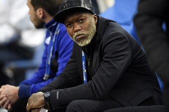 Bastia French forward Djibril Cisse watches play on April 11, 2015 during a French League Cup final football match Bastia (SCB) vs. Paris Saint-Germain, at the Stade de France in Saint-Denis, outside Paris. AFP PHOTO / LOIC VENANCE        (Photo credit sh