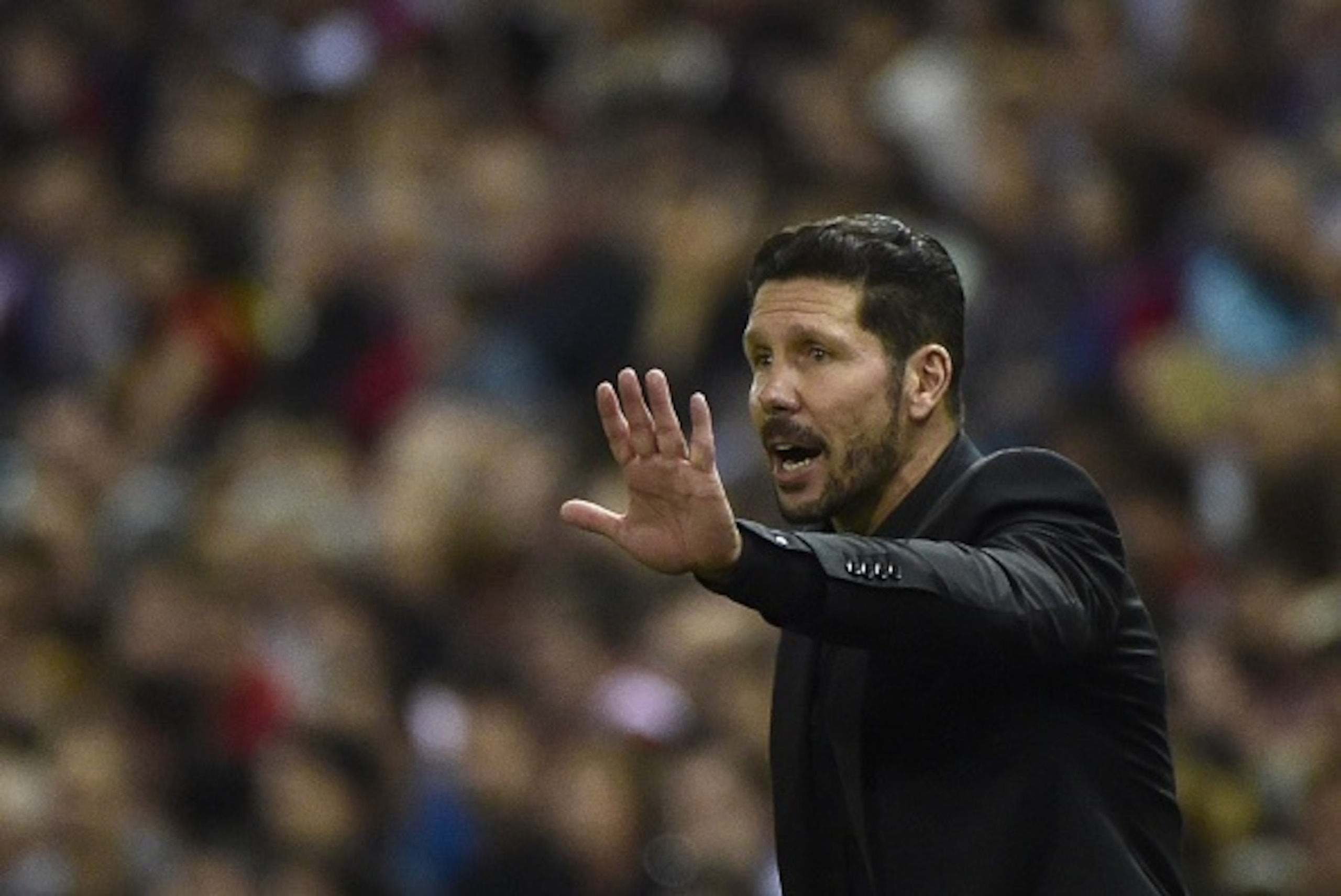 Atletico Madrid's Argentinian coach Diego Simeone gestures during the Spanish league football match Club Atletico de Madrid vs Real Madrid CF at the Vicente Calderon stadium in Madrid on October 4, 2015.   AFP PHOTO/ PIERRE-PHILIPPE MARCOU        (Photo c