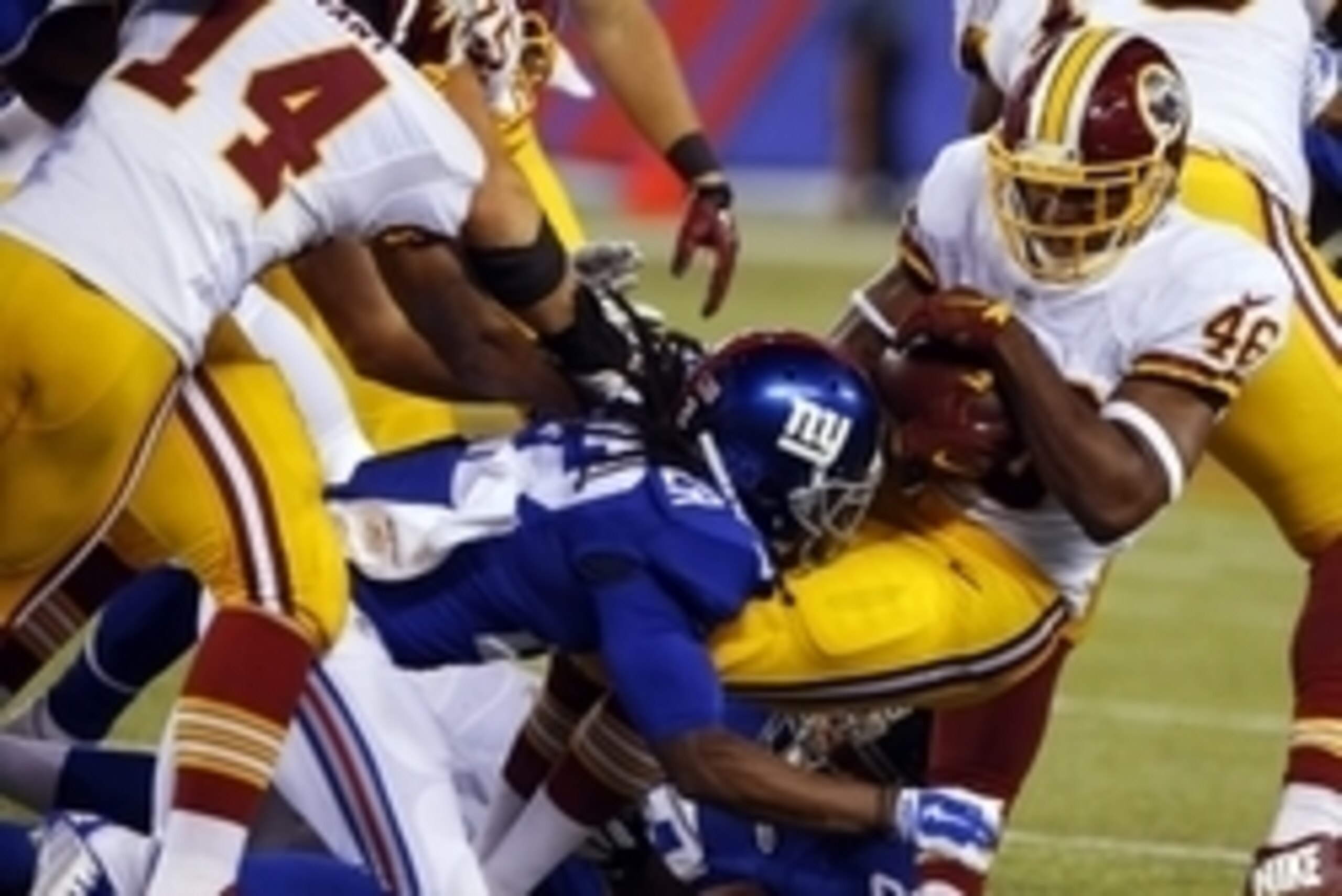 Sep 24, 2015; East Rutherford, NJ, USA; Washington Redskins running back Alfred Morris (46) is stopped by New York Giants strong safety Brandon Meriweather (22) and New York Giants defensive end Cullen Jenkins (99) during first half at MetLife Stadium. Ma