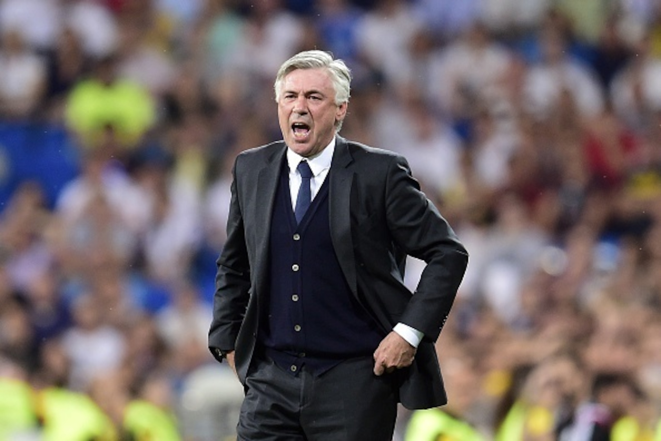Real Madrid's Italian coach Carlo Ancelotti gestures during the Spanish league football match Real Madrid CF vs Valencia CF at the Santiago Bernabeu stadium in Madrid on May 9, 2015. The game ended with a draw 2-2.    AFP PHOTO/ GERARD JULIEN        (Phot