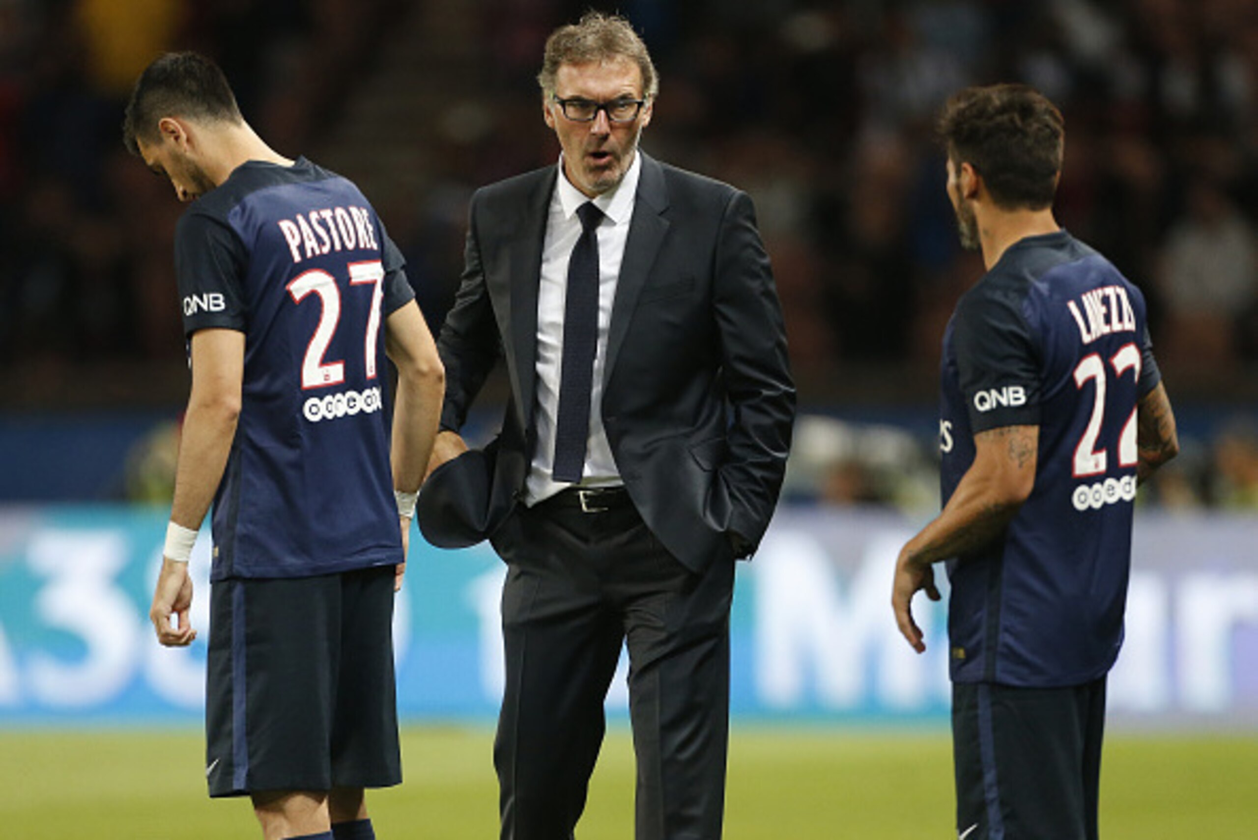 PARIS - AUGUST 16: Head coach of PSG Laurent Blanc motivate Javier Pastore and Ezequiel Lavezzi of PSG before they enter the field during the French Ligue 1 match between Paris Saint-Germain FC (PSG) and GFC Ajaccio (Gazelec Ajaccio) at Parc des Princes s
