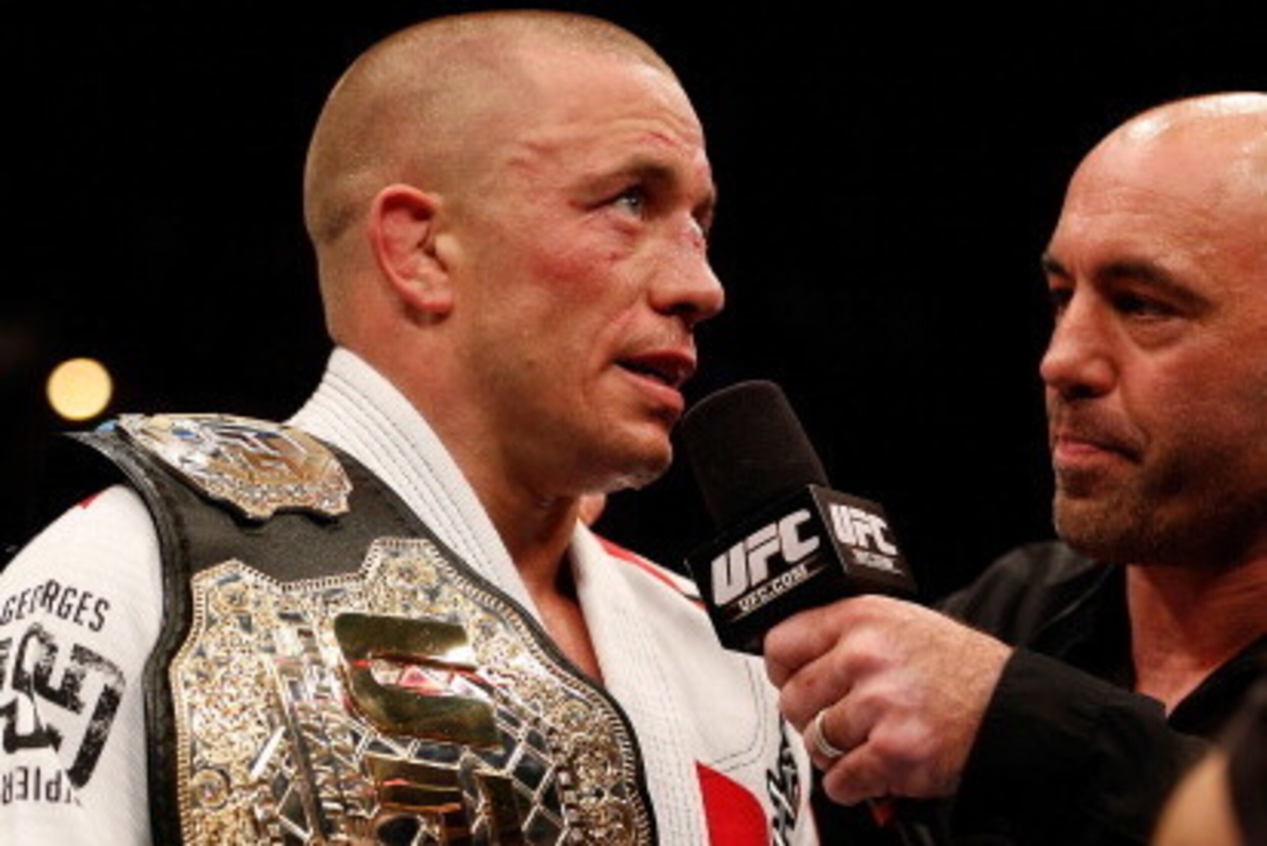 MONTREAL, QC - MARCH 16:  (L-R) Georges St-Pierre is interviewed by Joe Rogan after his victory over Nick Diaz in their welterweight championship bout during the UFC 158 event at Bell Centre on March 16, 2013 in Montreal, Quebec, Canada.  (Photo by Josh H