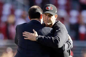 SANTA CLARA, CA - DECEMBER 28:  Head coach Jim Harbaugh of the San Francisco 49ers hugs 49ers CEO Jed York before their game against the Arizona Cardinals at Levi's Stadium on December 28, 2014 in Santa Clara, California.  (Photo by Ezra Shaw/Getty Images