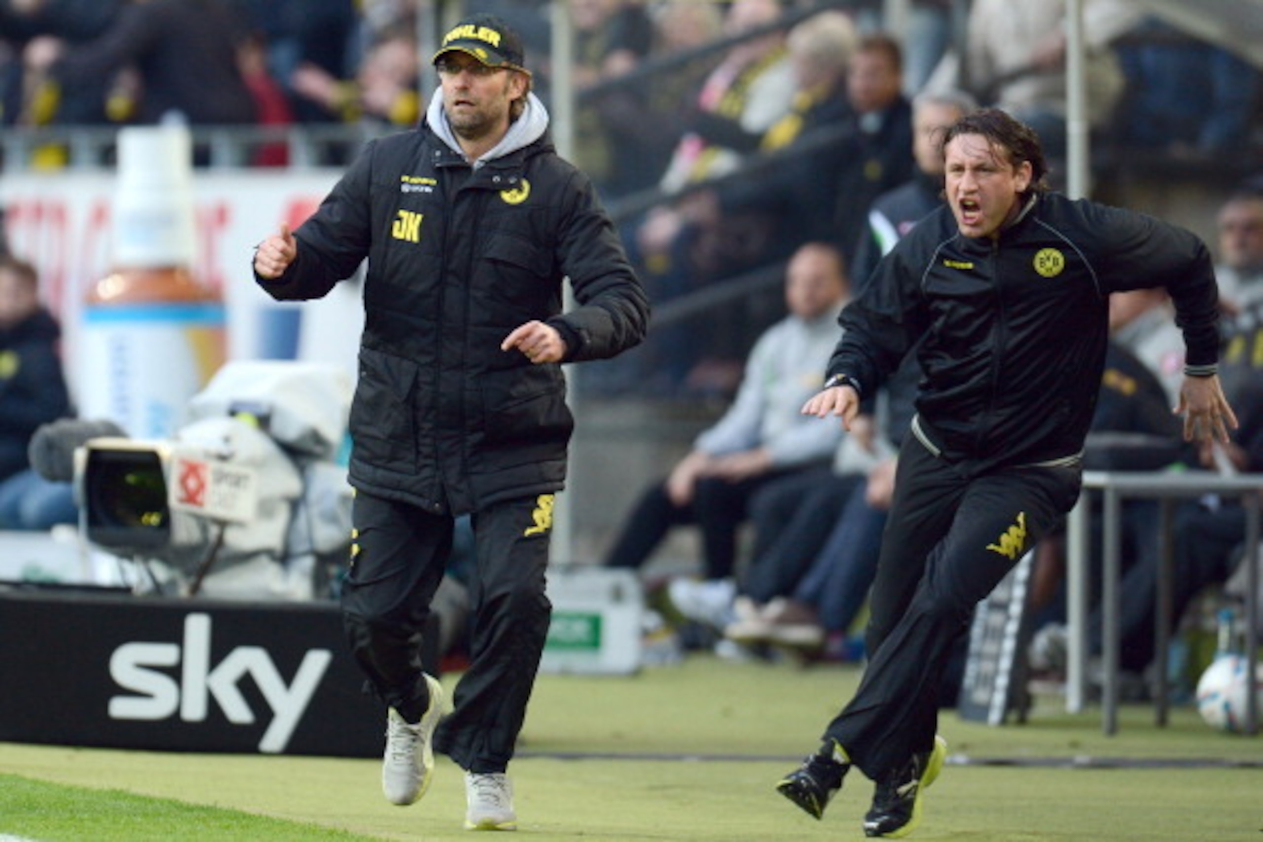 Dortmund's head coach Juergen Klopp (L) and his assistant-coach Zeljko Buvac celebrate during the German first division Bundesliga football match Borussia Dortmund vs Borussia Moenchengladbach in Dortmund, western Germany, on April 21, 2012. AFP PHOTO / P