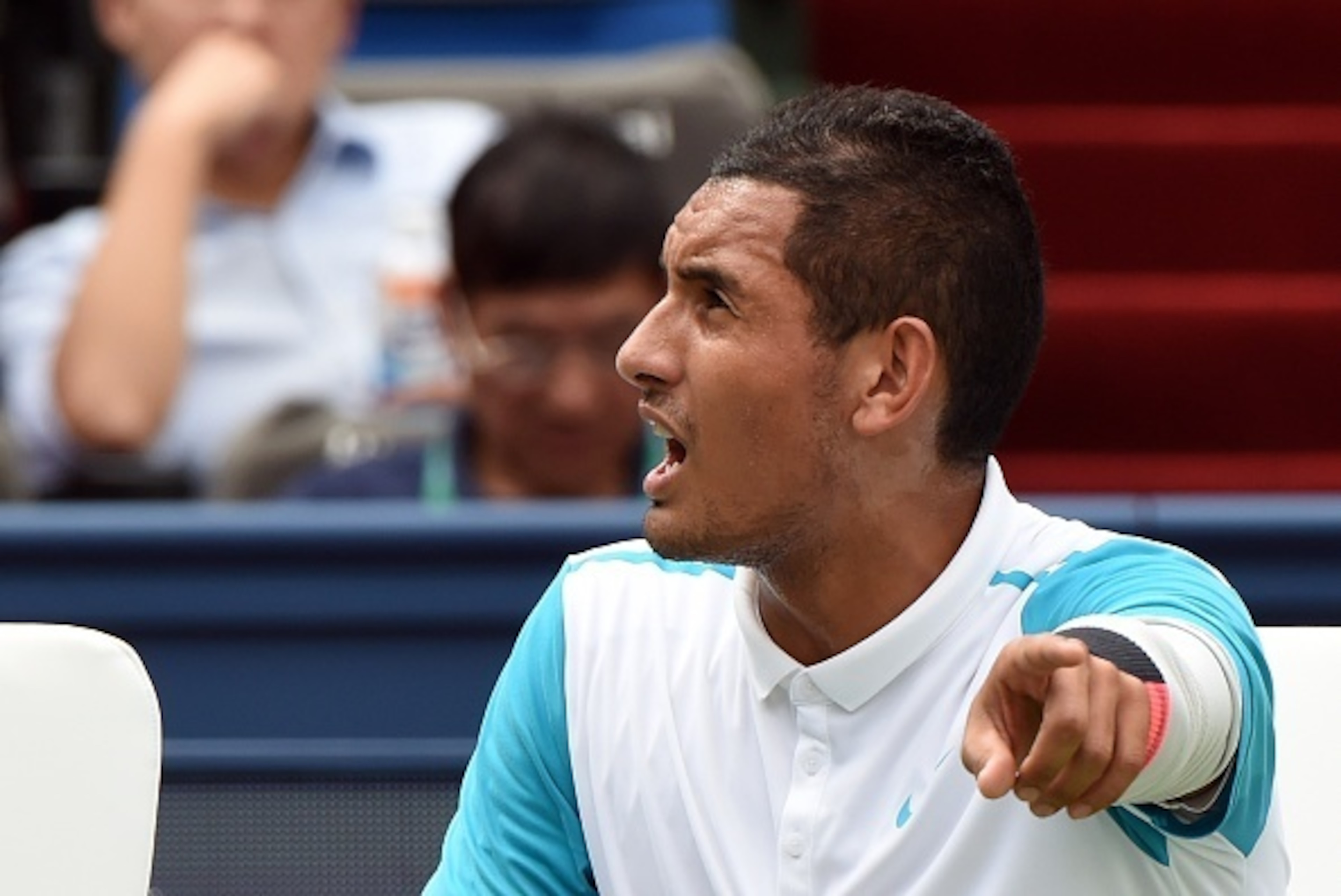 Nick Kyrgios of Australia argues with the umpire during his men's singles second round match against Kei Nishikori of Japan at the Shanghai Masters tennis tournament in Shanghai on October 14, 2015. AFP PHOTO / GREG BAKER        (Photo credit should read 