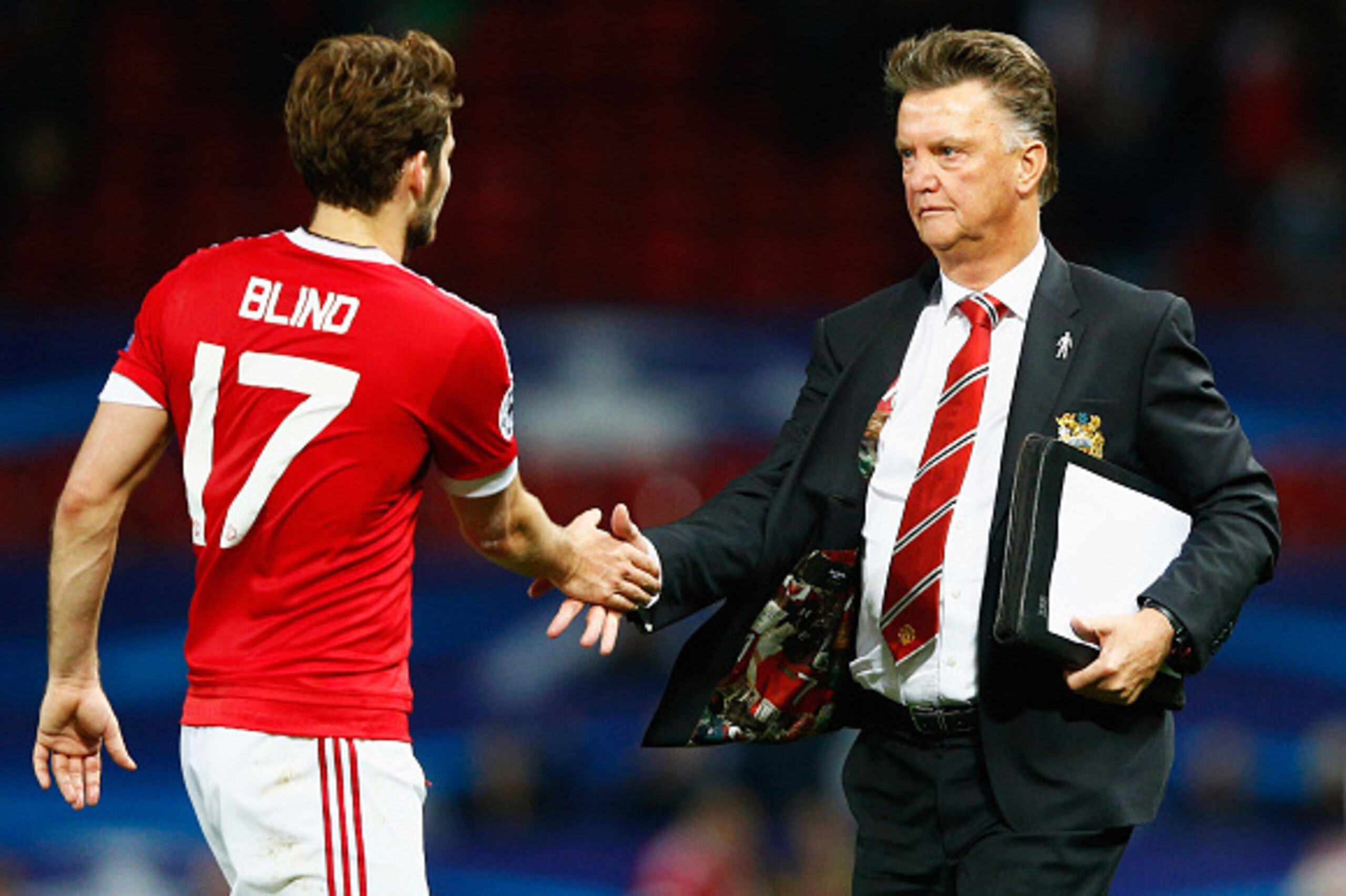 MANCHESTER, ENGLAND - SEPTEMBER 30:  Louis van Gaal manager of Manchester United shakes hand with Daley Blind of Manchester United after victory in the UEFA Champions League Group B match between Manchester United FC and VfL Wolfsburg at Old Trafford on S