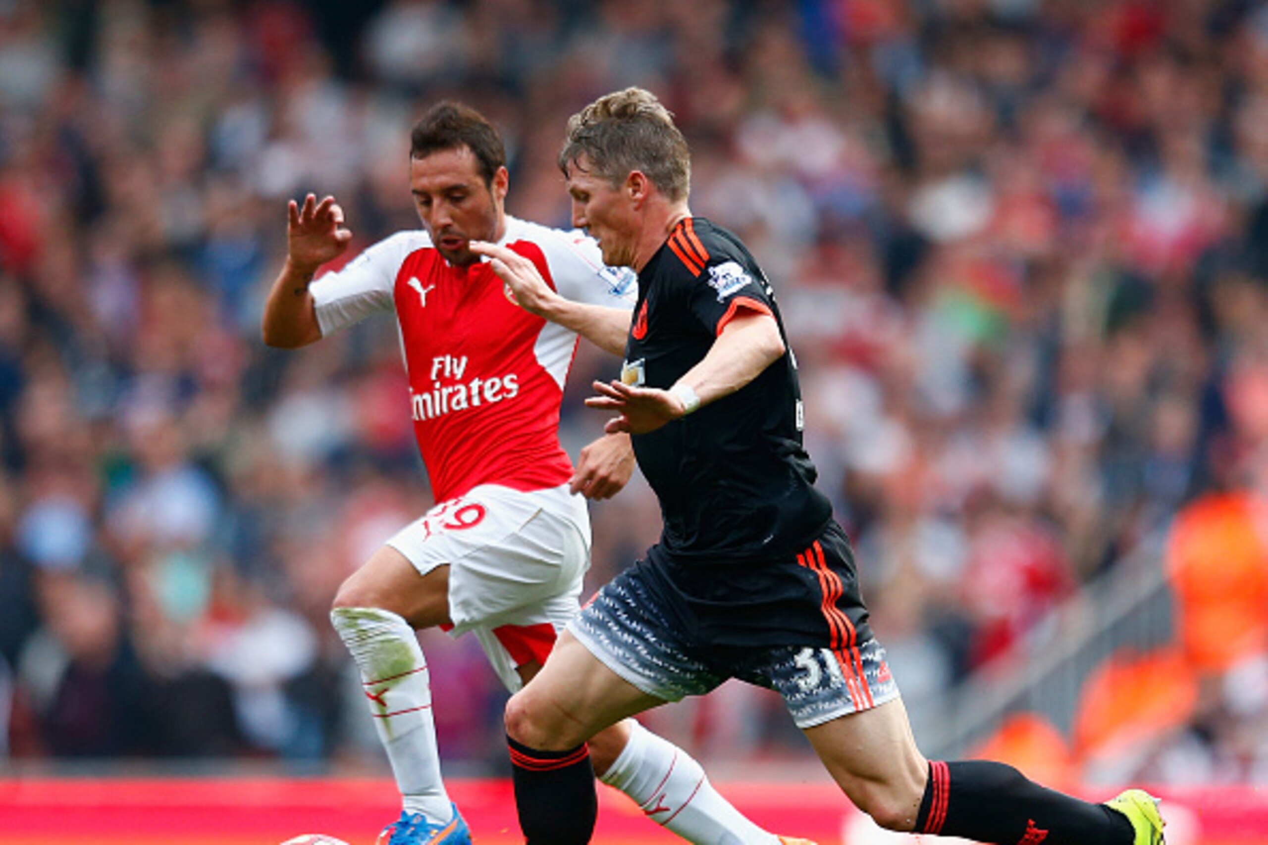 LONDON, ENGLAND - OCTOBER 04: Santi Cazorla of Arsenal and Bastian Schweinsteiger of Manchester United compete for the ball during the Barclays Premier League match between Arsenal and Manchester United at Emirates Stadium on October 4, 2015 in London, E LONDON, ENGLAND - OCTOBER 04: Santi Cazorla of Arsenal and Bastian Schweinsteiger of Manchester United compete for the ball during the Barclays Premier League match between Arsenal and Manchester United at Emirates Stadium on October 4, 2015 in London, E