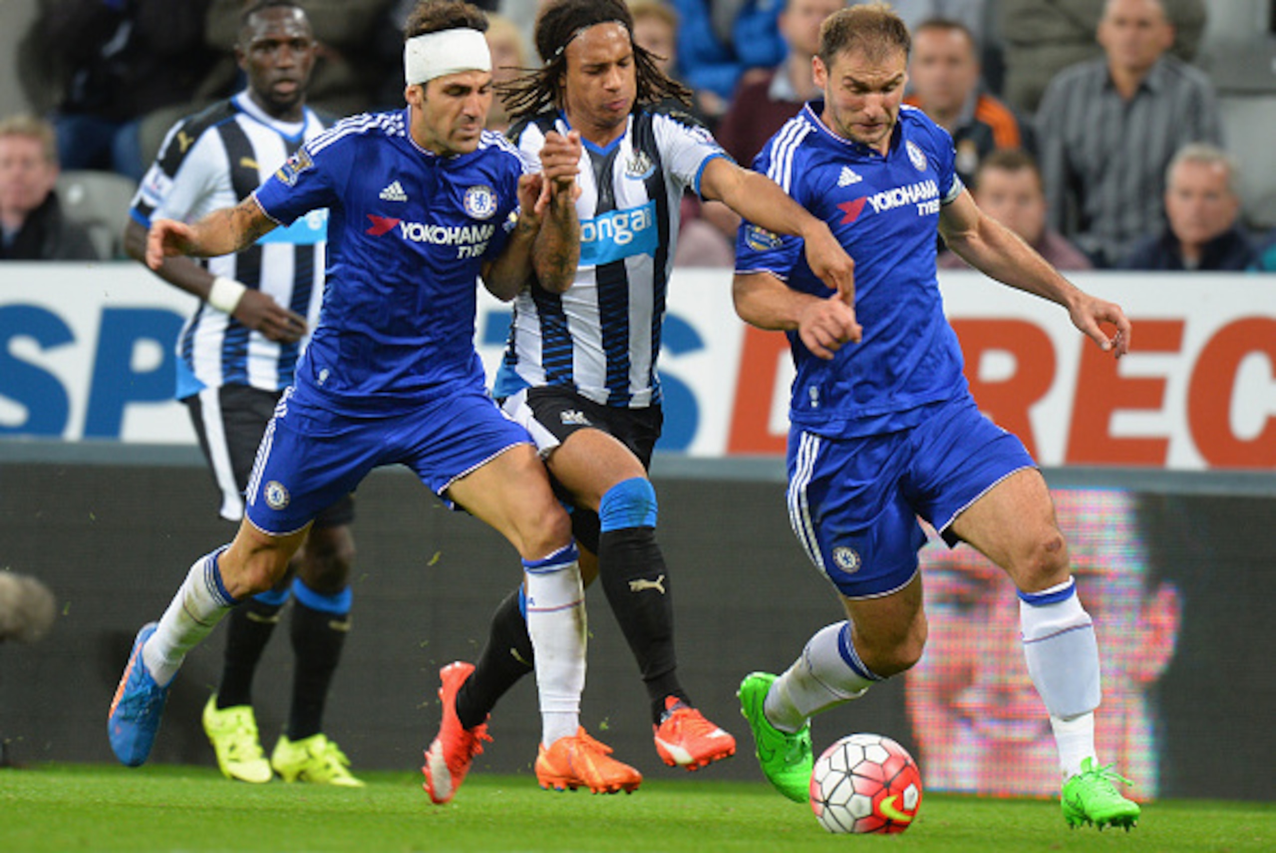 NEWCASTLE UPON TYNE, ENGLAND - SEPTEMBER 26:  Kevin Nbabu (C)of Newcastle United competes against Sesc Fabregas (L) and Branislav Ivanovic (R) of Chelsea  during the Barclays Premier League match between Newcastle United and Chelsea at St James' Park on S