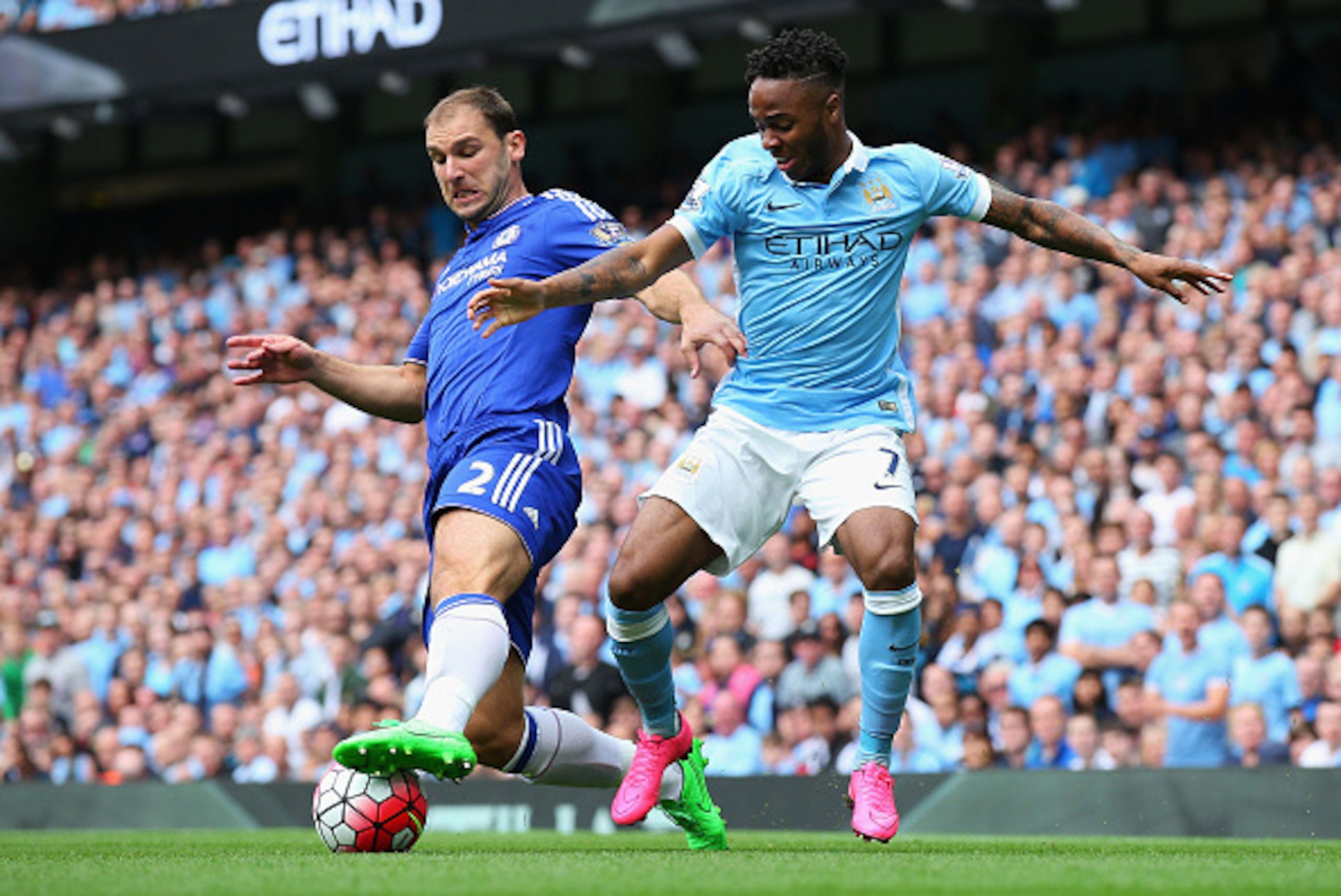 MANCHESTER, ENGLAND - AUGUST 16: Raheem Sterling of Manchester City takes on Branislav Ivanovic of Chelsea during the Barclays Premier League match between Manchester City and Chelsea at the Etihad Stadium on August 16, 2015 in Manchester, England.  (Phot
