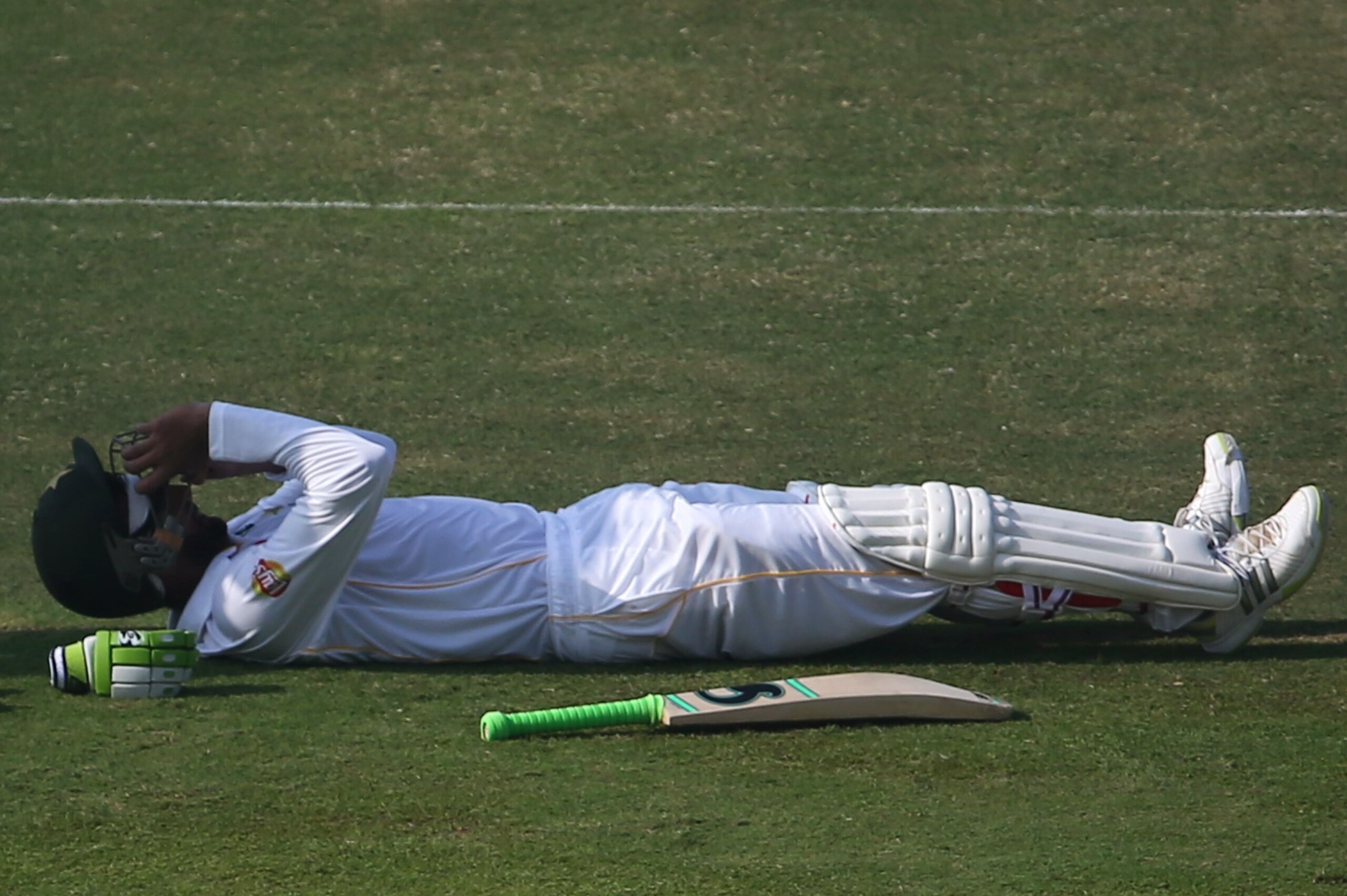 Pakistan's Shoaib Malik lies on the field recovering from a cramp attack during the second day's play of the first cricket Test match between Pakistan and England at The Sheikh Zayed International Cricket Stadium in Abu Dhabi on October 14, 2015. AFP PHO Pakistan's Shoaib Malik lies on the field recovering from a cramp attack during the second day's play of the first cricket Test match between Pakistan and England at The Sheikh Zayed International Cricket Stadium in Abu Dhabi on October 14, 2015. AFP PHO