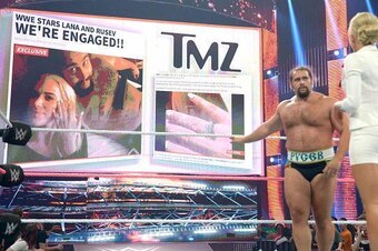 Summer Rae shows Rusev the TMZ report about his engagement to Lana.