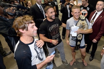 LAS VEGAS, NV - MAY 24:  (L-R) Urijah Faber, Chad Mendes, T.J. Dillashaw and Fabio Prado celebrate T.J.'s victory over Renan Barao in their bantamweight championship bout during the UFC 173 event at the MGM Grand Garden Arena on May 24, 2014 in Las Vegas,