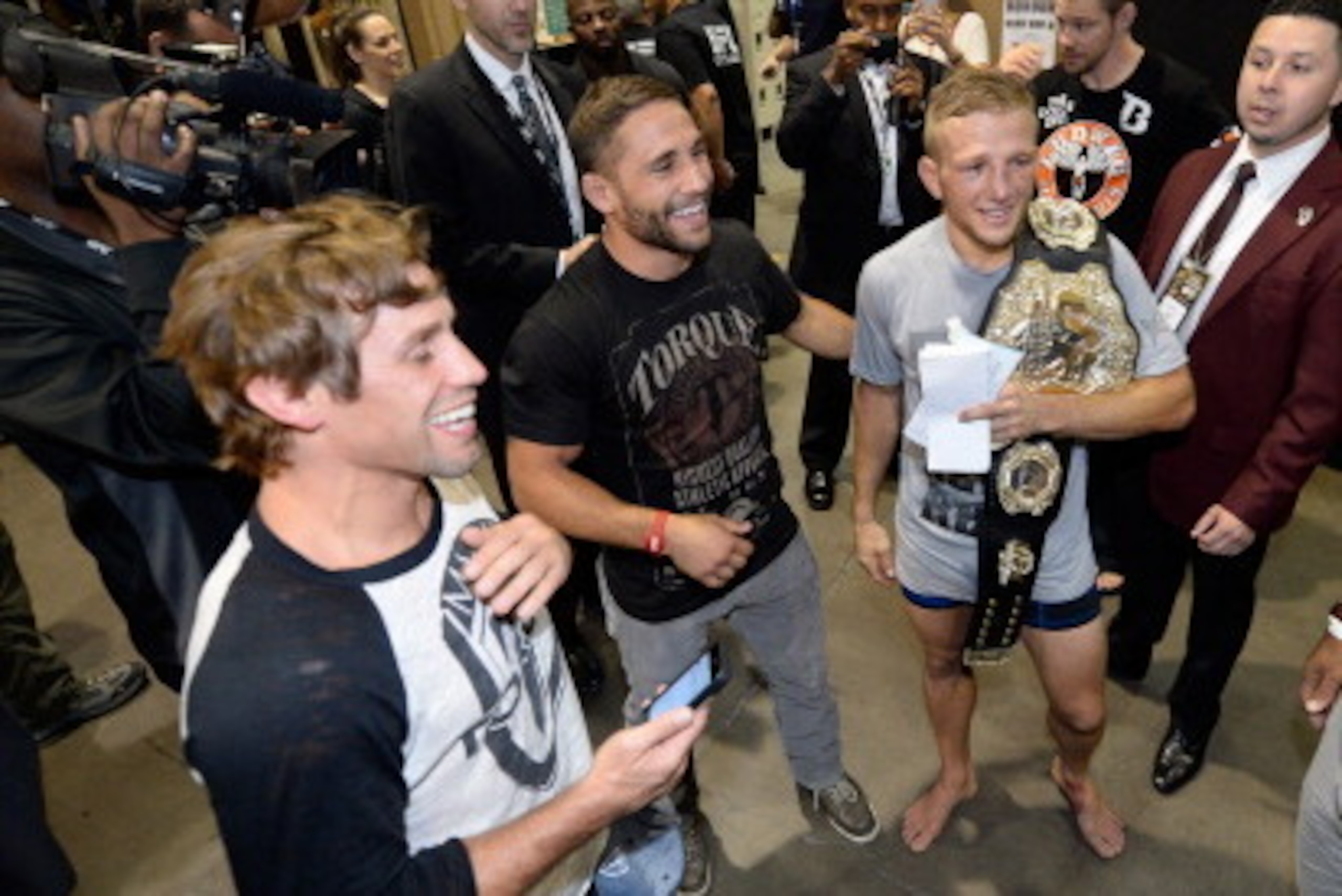 LAS VEGAS, NV - MAY 24:  (L-R) Urijah Faber, Chad Mendes, T.J. Dillashaw and Fabio Prado celebrate T.J.'s victory over Renan Barao in their bantamweight championship bout during the UFC 173 event at the MGM Grand Garden Arena on May 24, 2014 in Las Vegas,