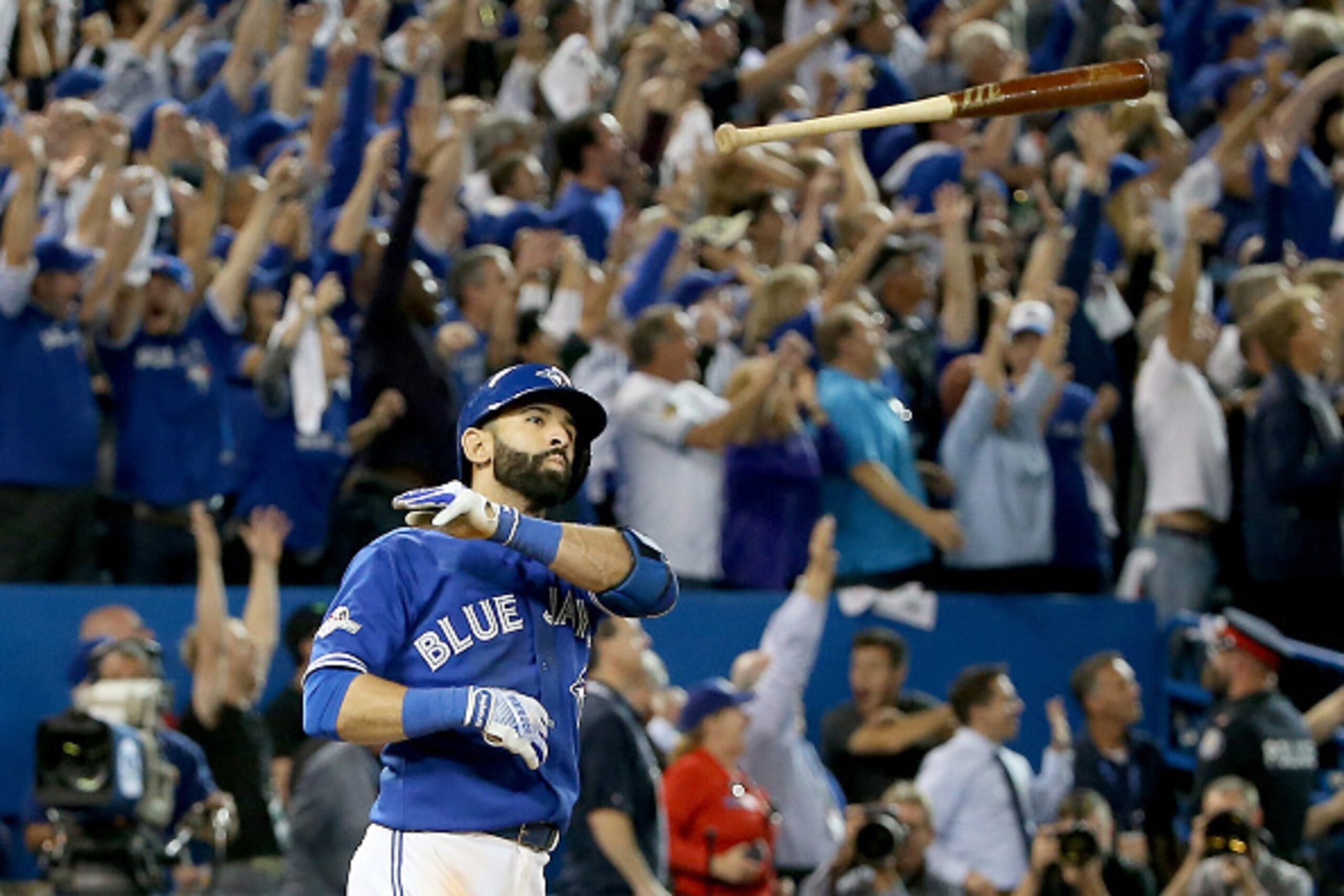 TORONTO, ON - OCTOBER 14:  Jose Bautista #19 of the Toronto Blue Jays throws his bat up in the air after he hits a three-run home run in the seventh inning against the Texas Rangers in game five of the American League Division Series at Rogers Centre on O