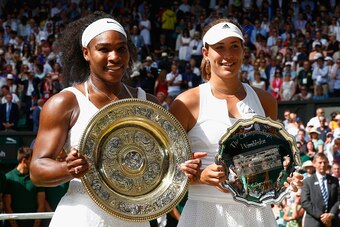 LONDON, ENGLAND - JULY 11:  Serena Williams of the United States holds the Venus Rosewater Dish next to Garbine Muguruza of Spain holding the runners up trophy after her victory in the Final Of The Ladies' Singles against during day twelve of the Wimbledo