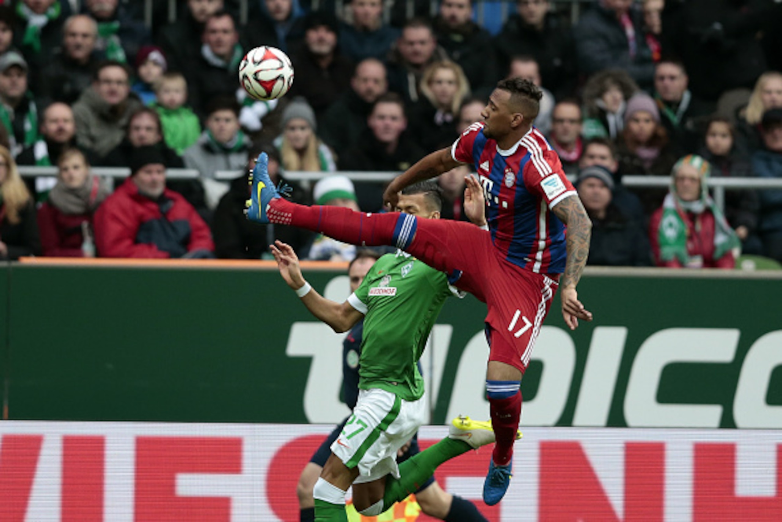 BREMEN, GERMANY - MARCH 14: Jerome Boateng (R) of Munich and Davie Selke (L) of Bremen compete for the ball during the First Bundesliga match between SV Werder Bremen and FC Bayern Muenchen at Weserstadion on March 14, 2015 in Bremen, Germany.  (Photo by 
